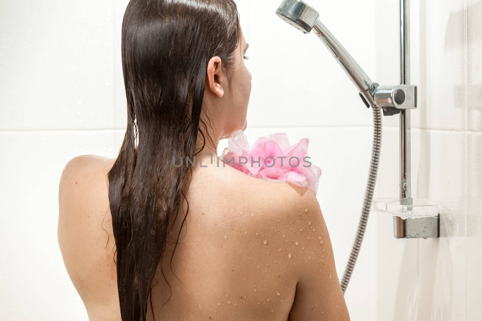 Beautiful slim woman washing in shower