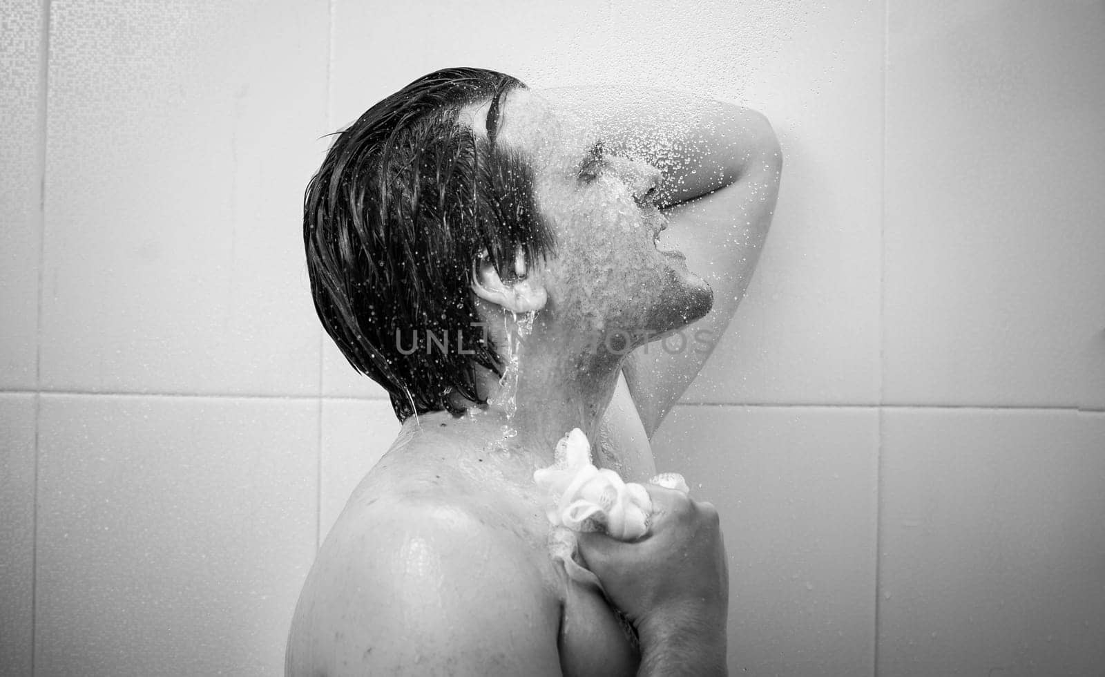 Black and white closeup portrait of smiling man at douche