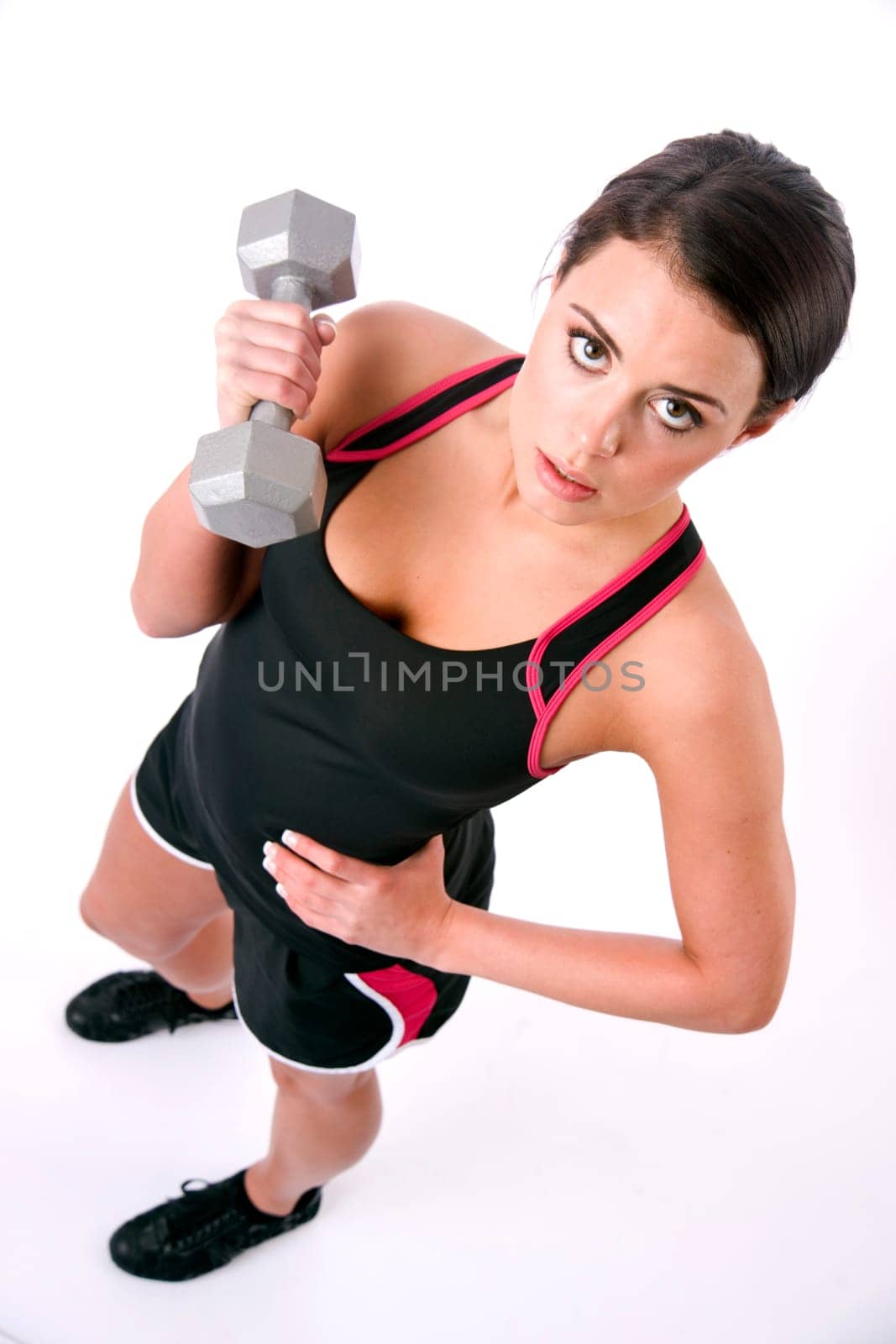 Young adult woman tones her muscle on the weights with some curling
