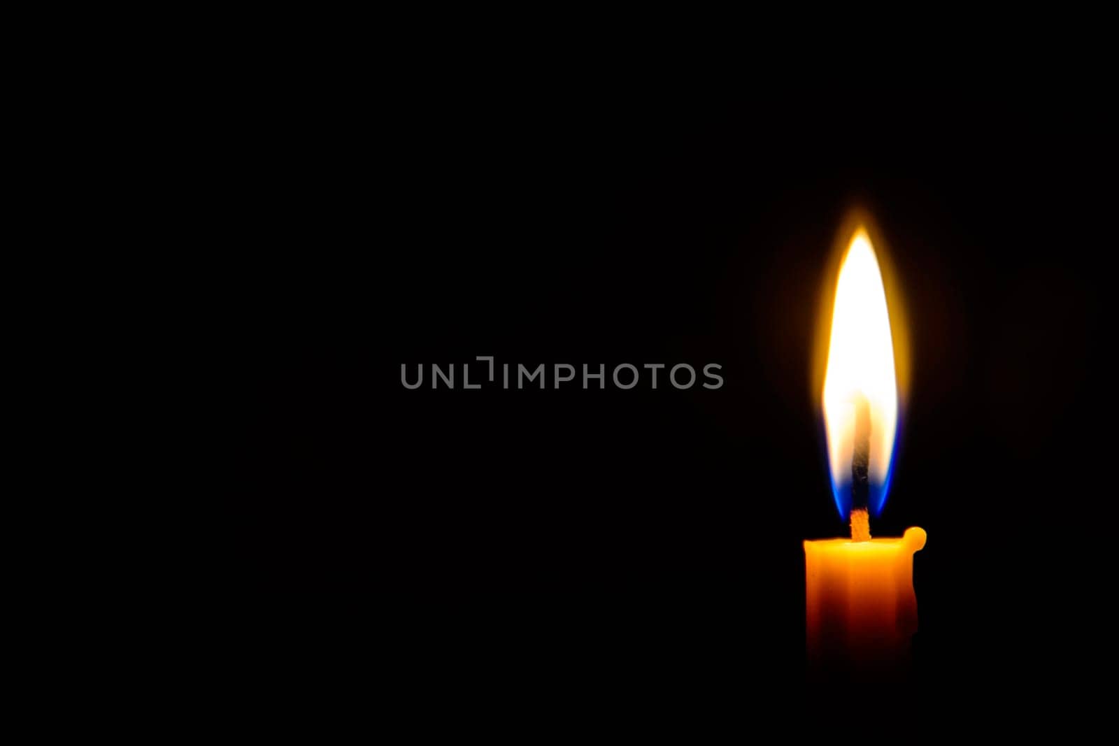 burning candle light in the dark
