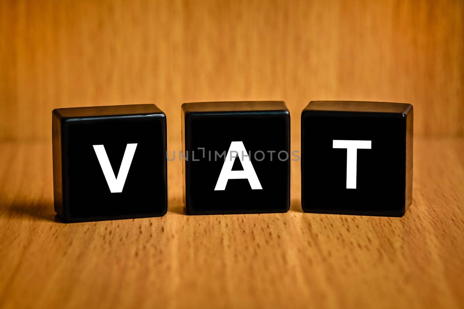 VAT or value added tax text on black block