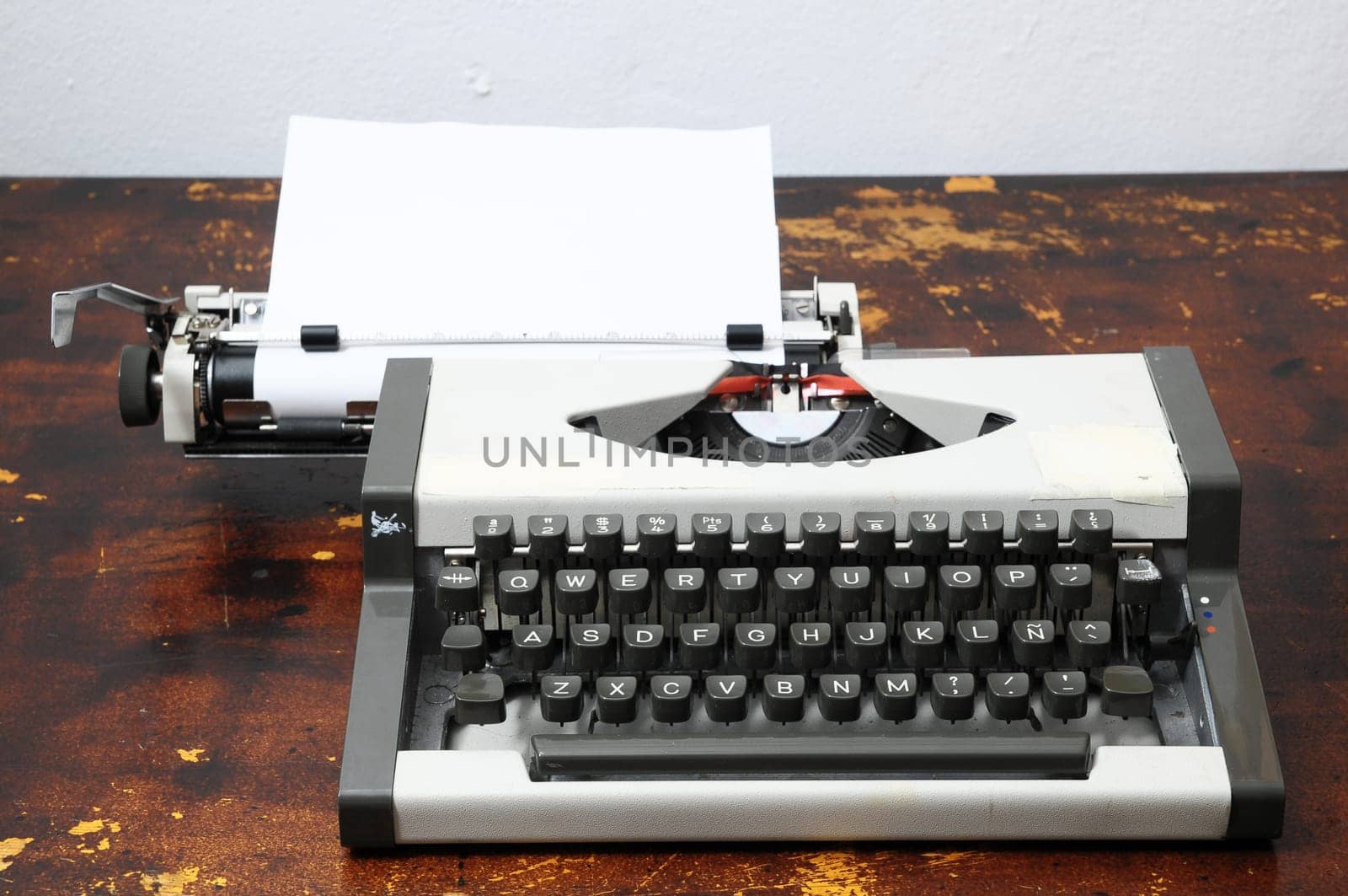 Old Vintage Travel Typewriter on a Brown Wooden Table