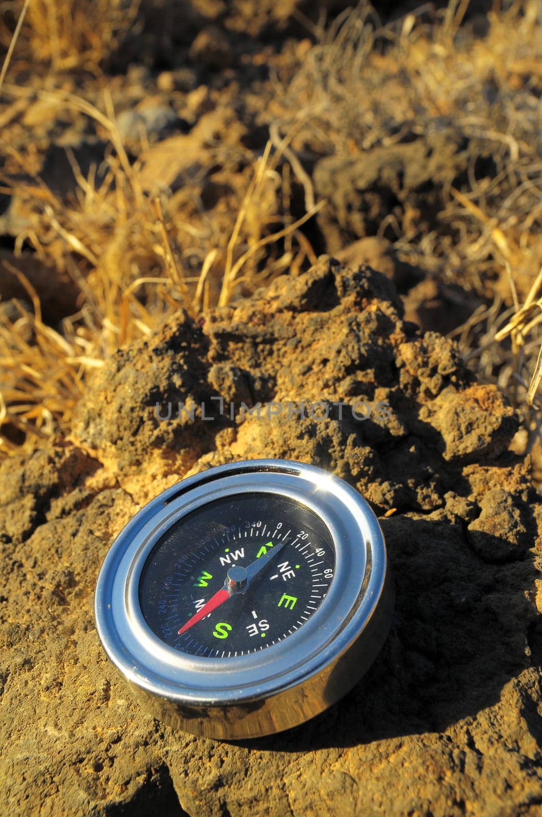 Orientation Concept Metal Compass on a Rock in the Desert