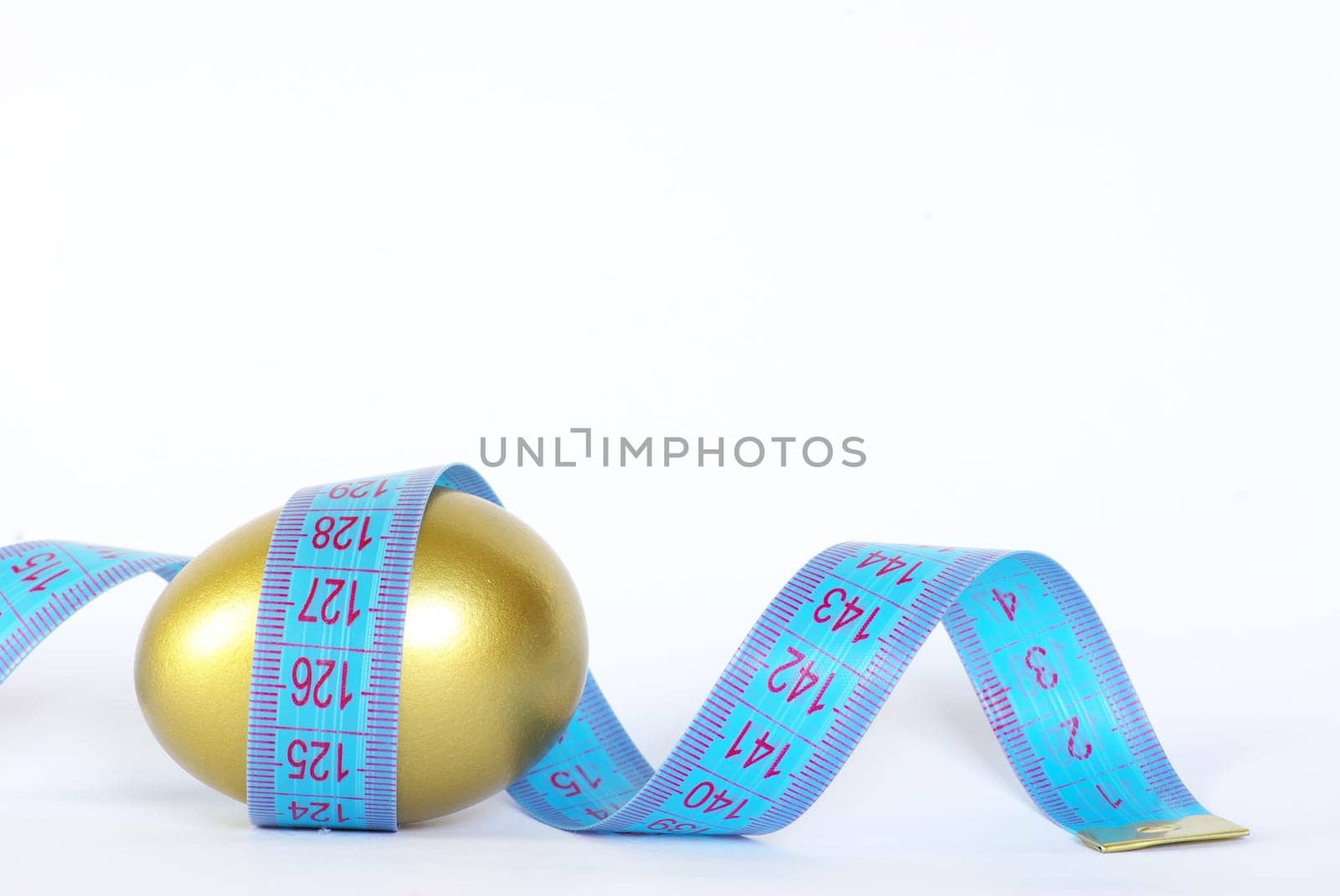 gold egg with measuring tape  around