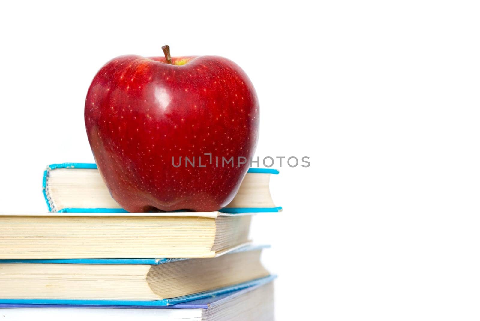 Red apple and stack of books for school