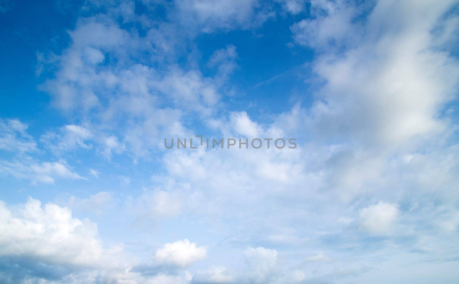 blue sky background with tiny clouds