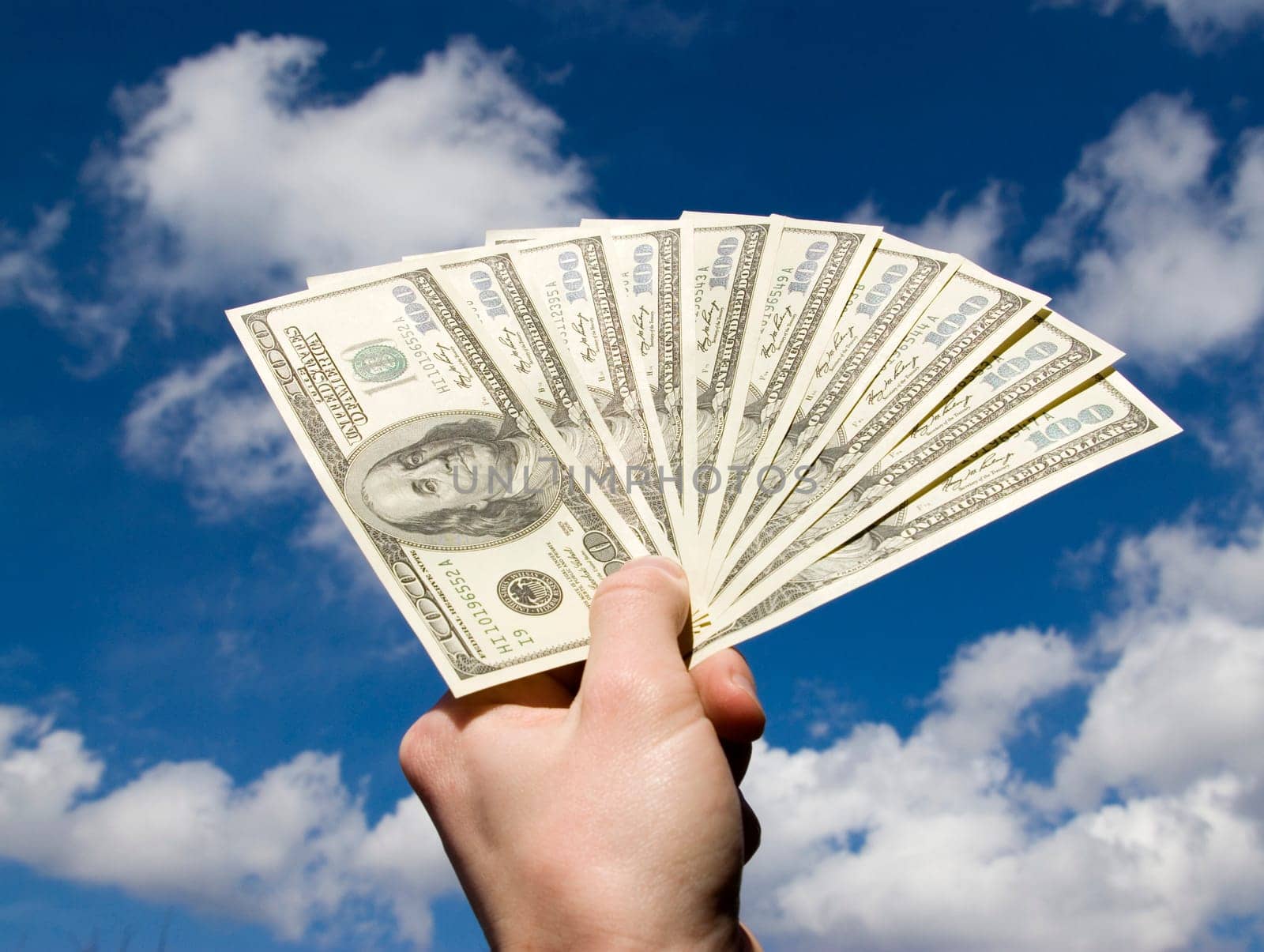 Money in hand  isolated on sky background