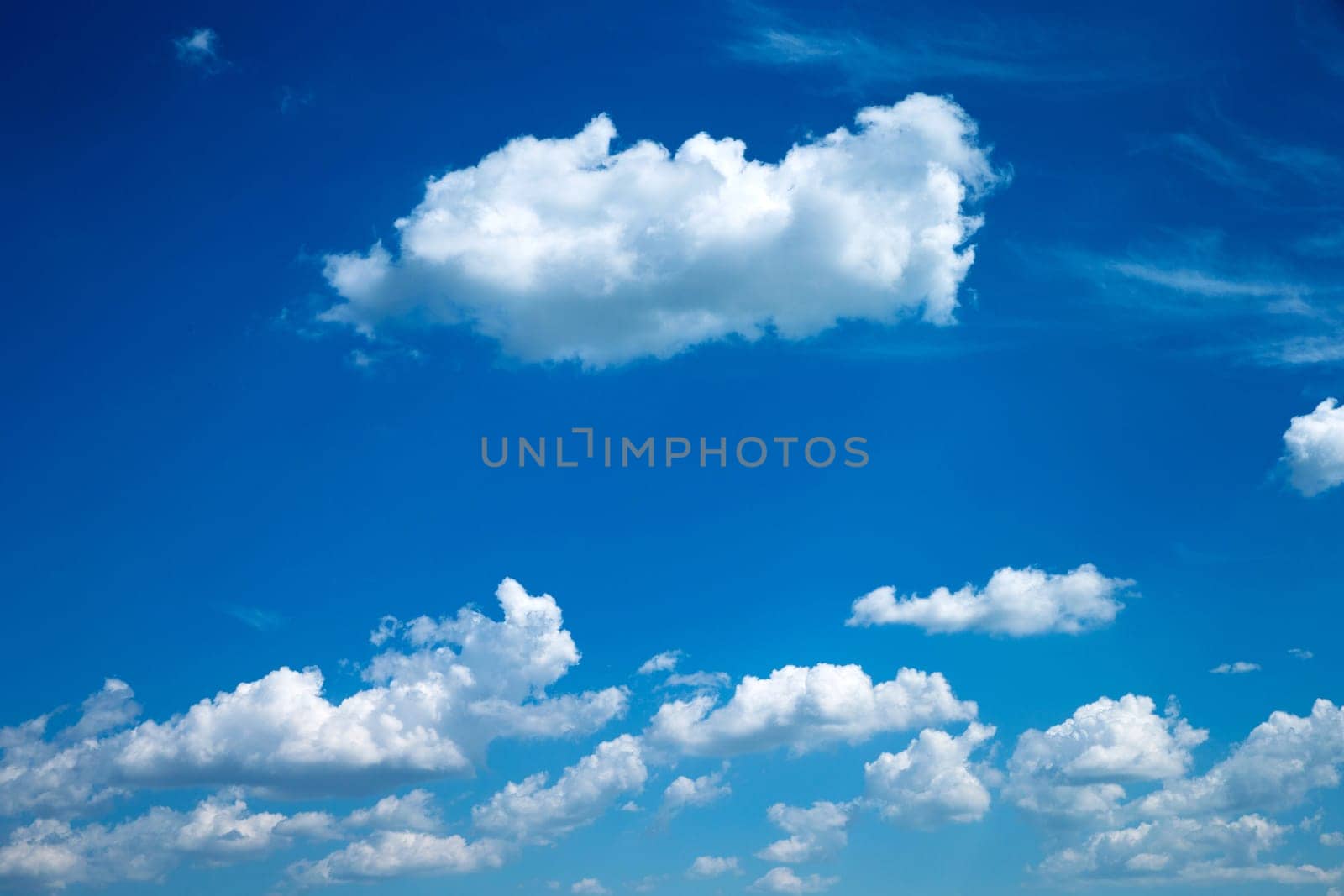 Blue sky background with a tiny clouds