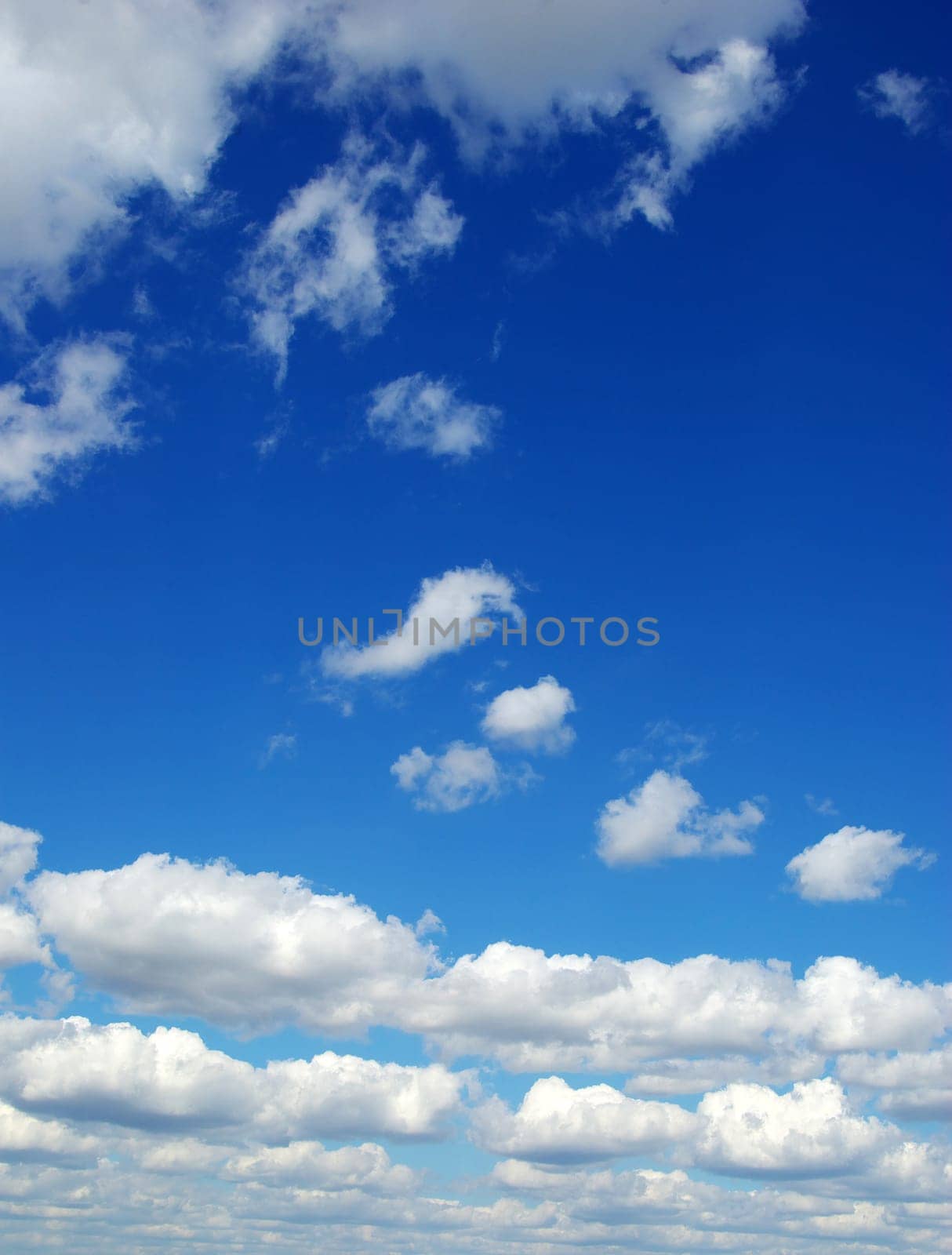 Blue sky background with tiny clouds