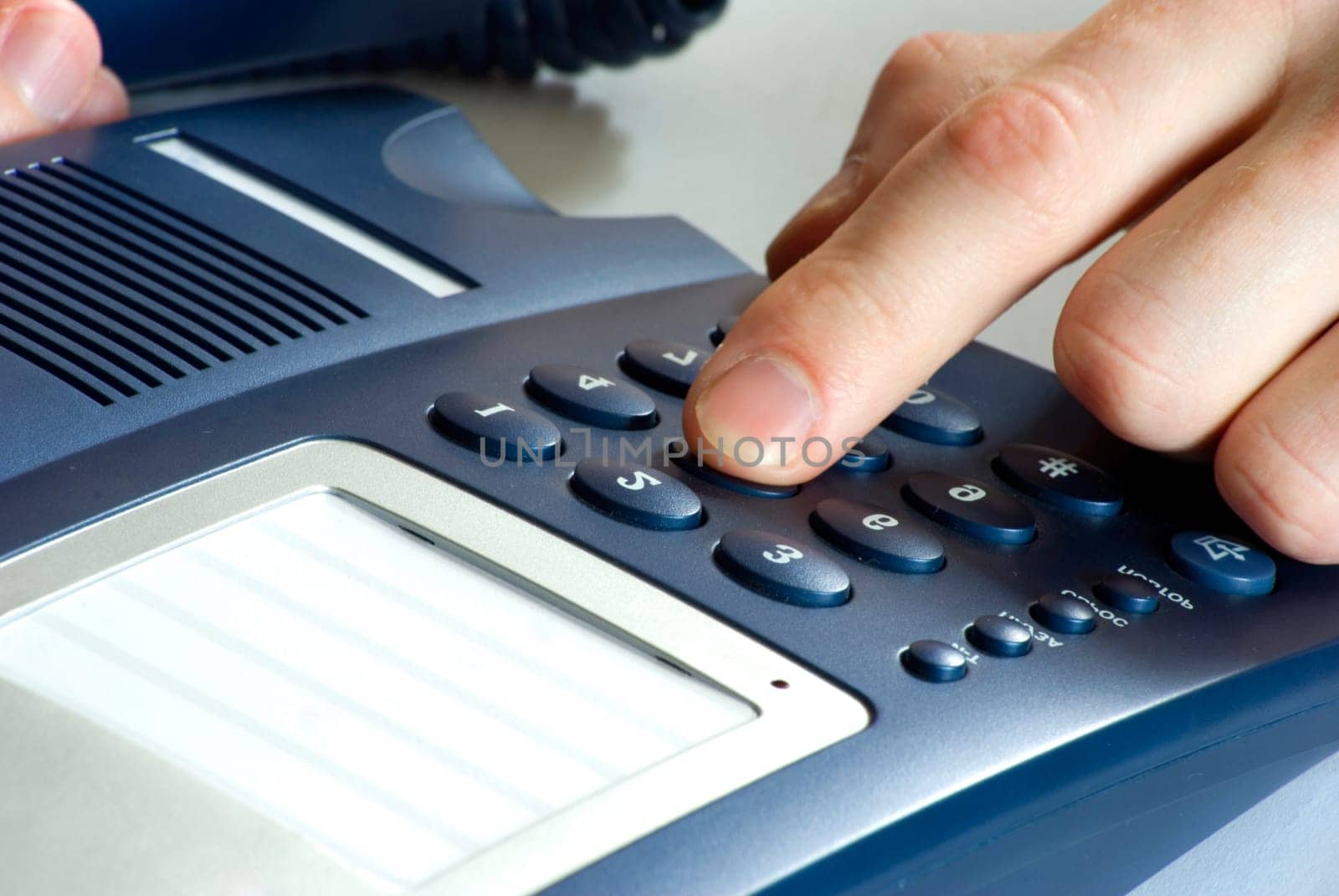 finger with  blue telephone keypad