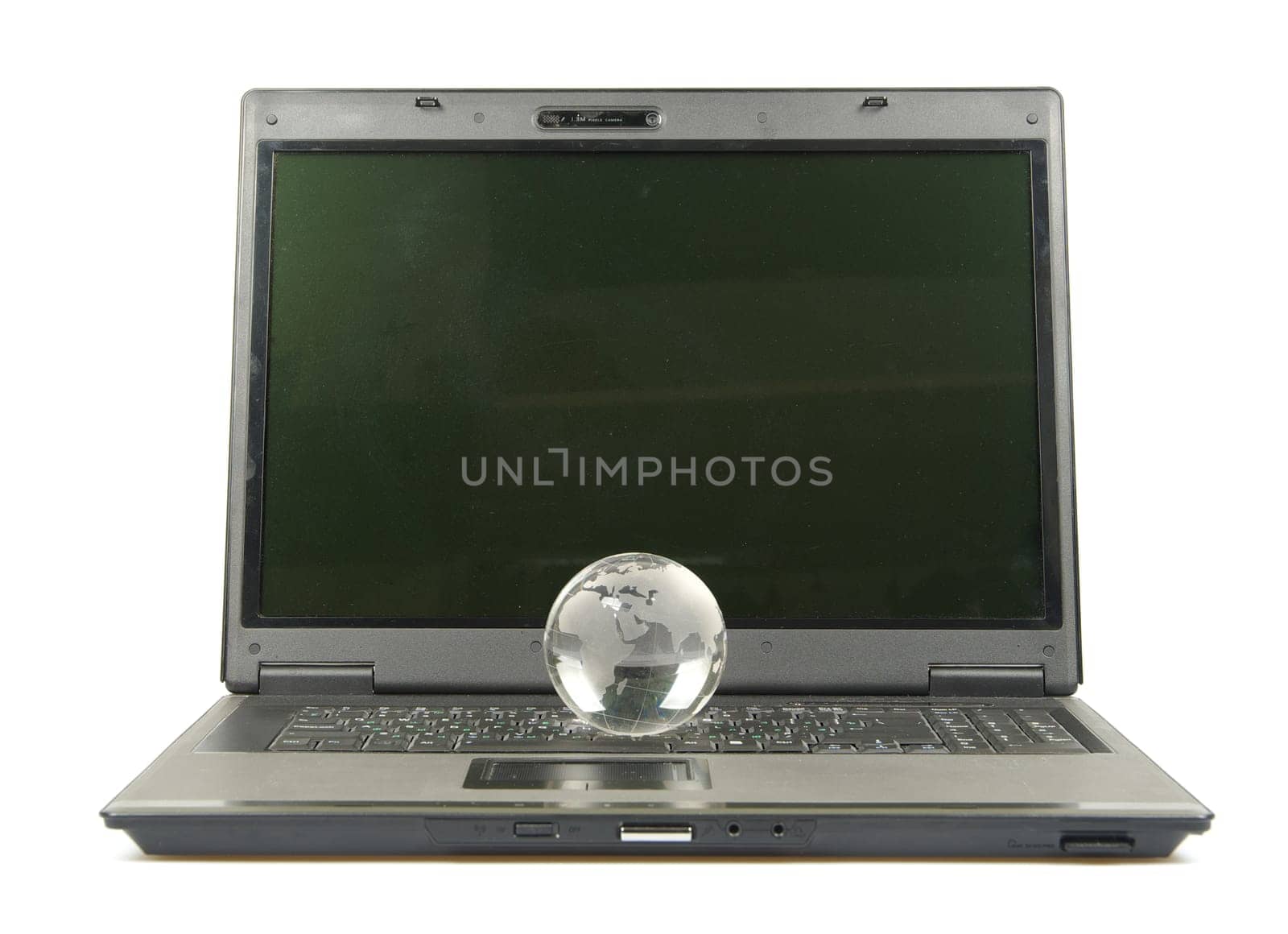 glass globe placed on a laptop isolated on white