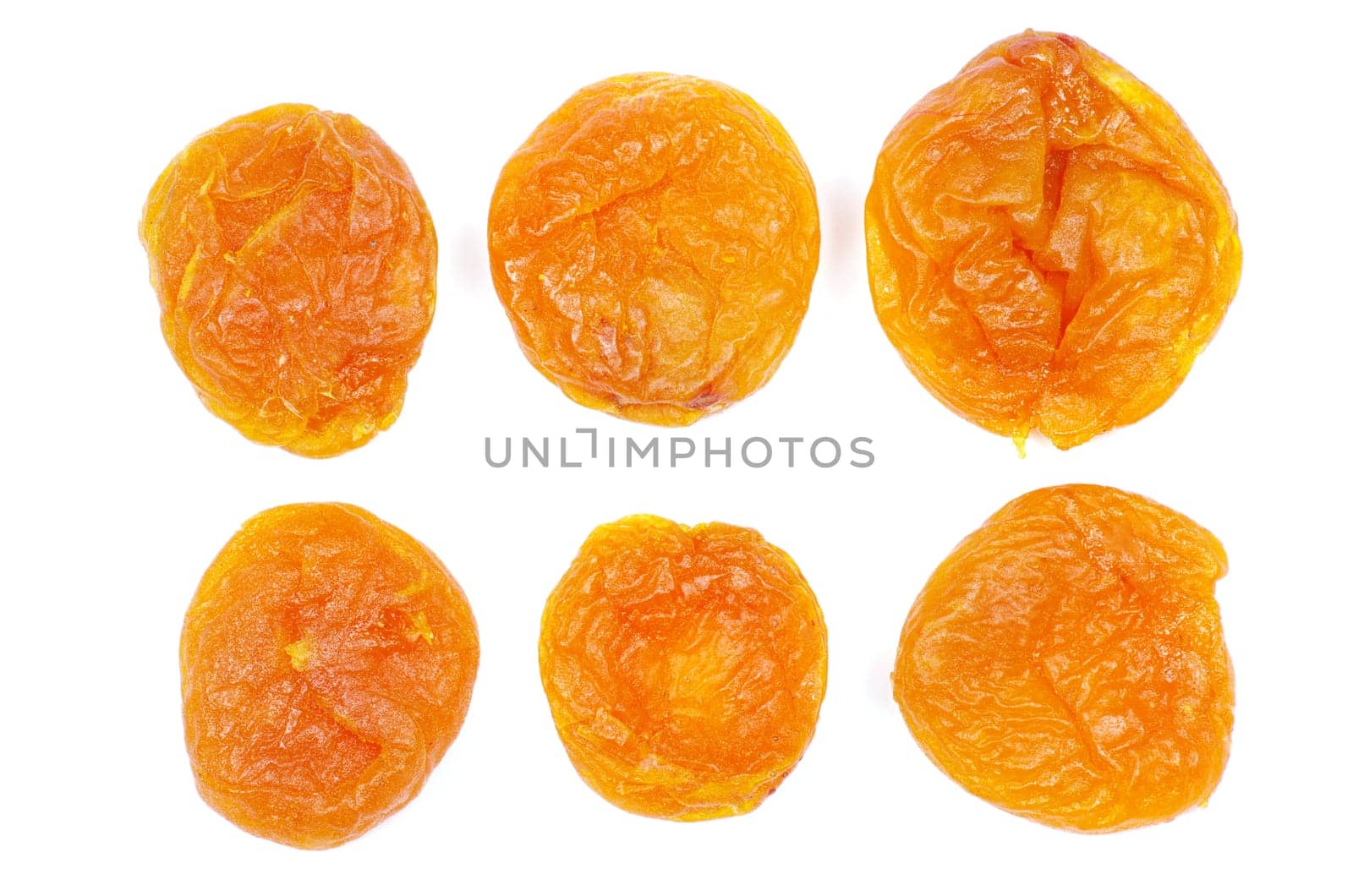 heap of dried apricots over white