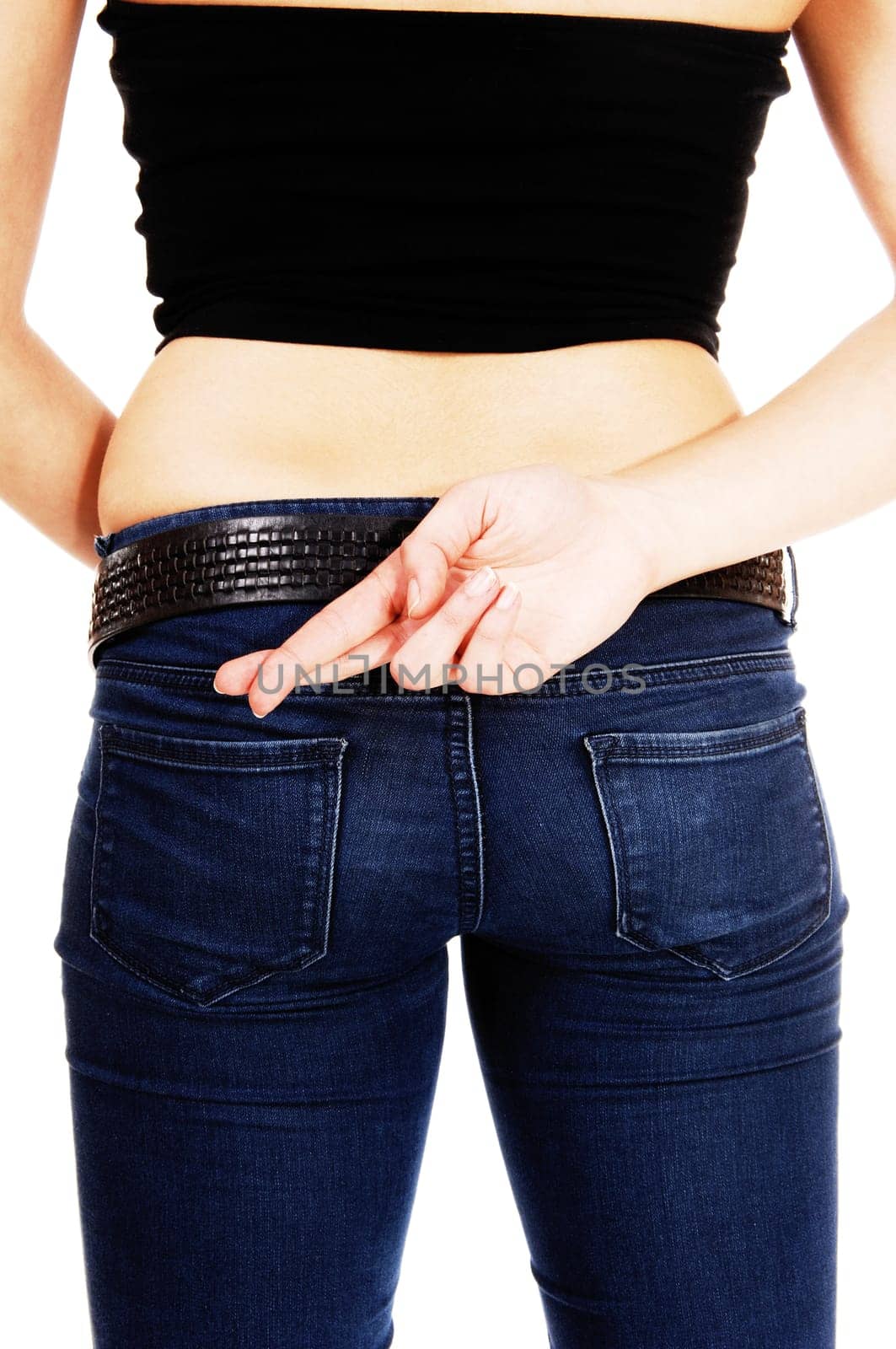 A closeup picture of the back and butt of a young woman in jeans with.her crossed finger, isolated on white background..
