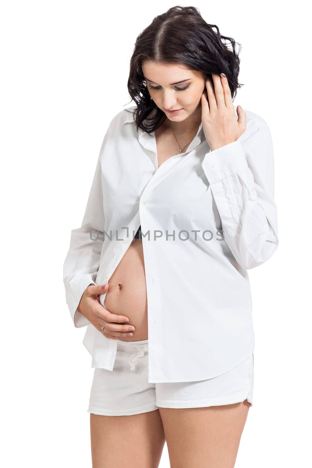 Pretty expectant mother with baby belly looking forward to her baby isolated against a white background