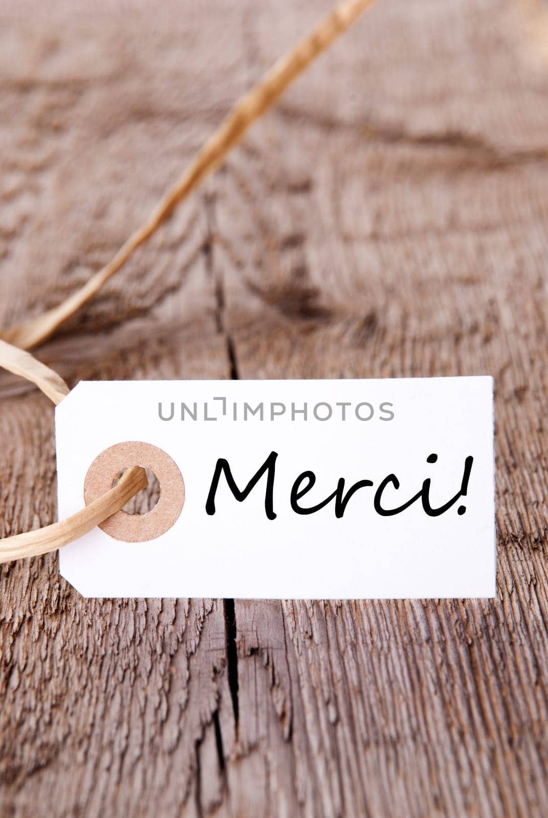 The French Word Merci which means Thanks on a Wooden Board
