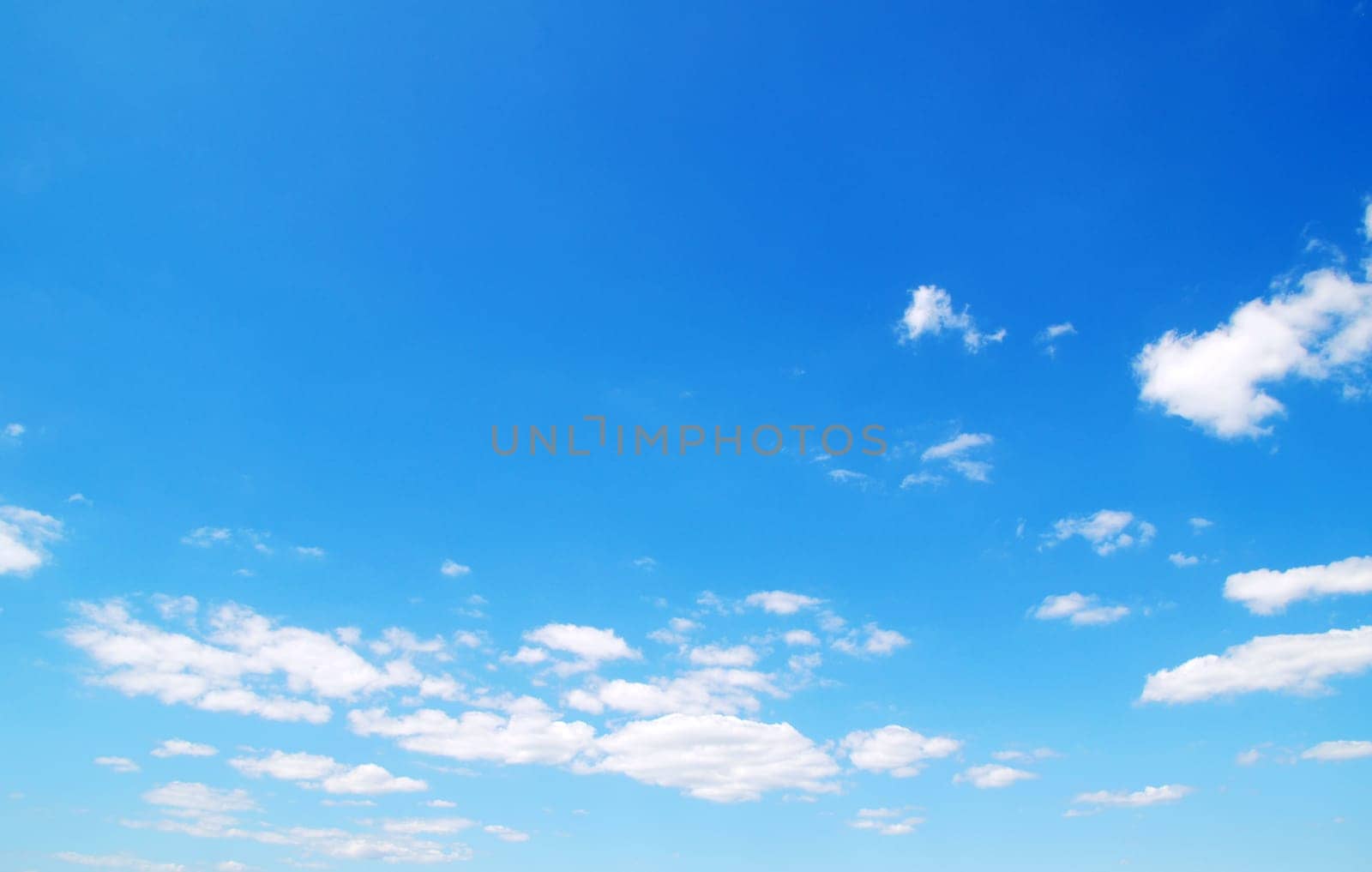 Blue sky background with a tiny clouds