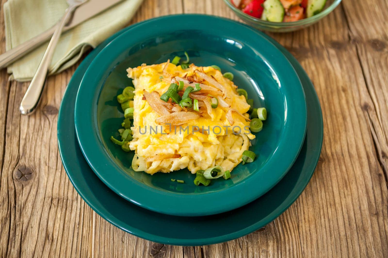 Plate of fresh cheese maccaroni or cheese chips in close-up on a wooden table