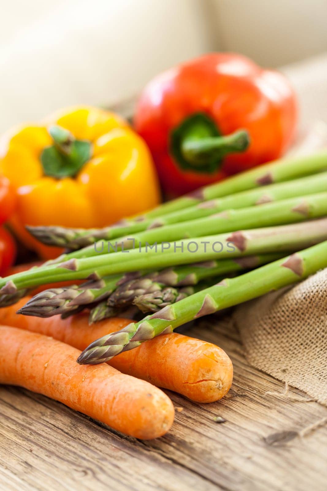 Fresh vegetables with tomatoes,peppers and asparagus as a close-up on an outdoor table