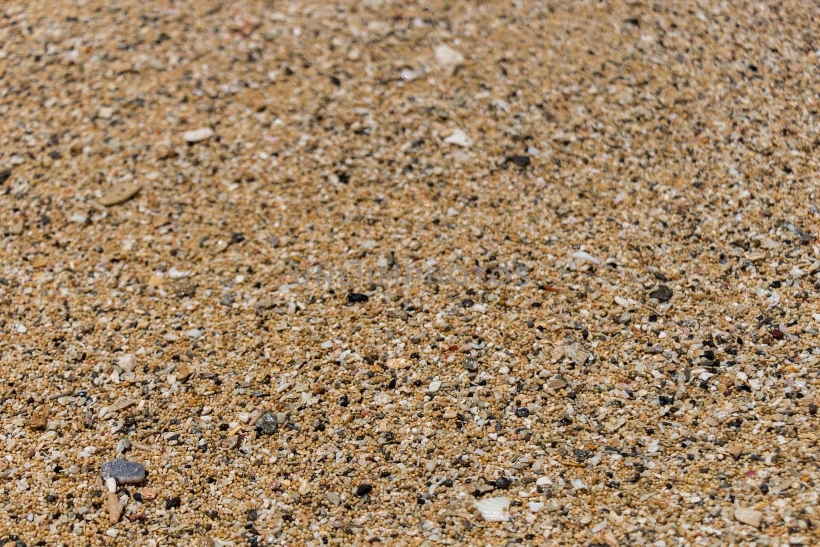 Sand gravel at the sea as a close-up as a background