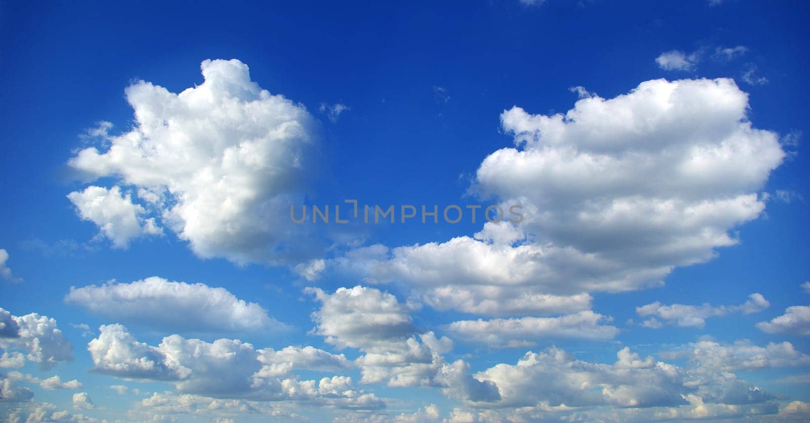 Blue sky background with tiny clouds