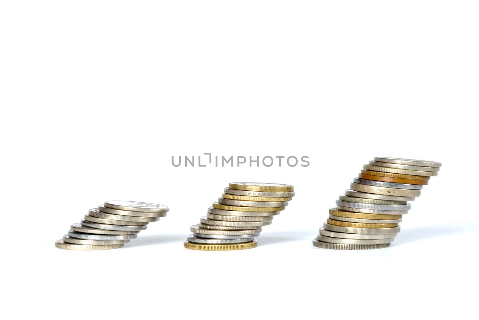 three towers of coins isolated on a whiteness