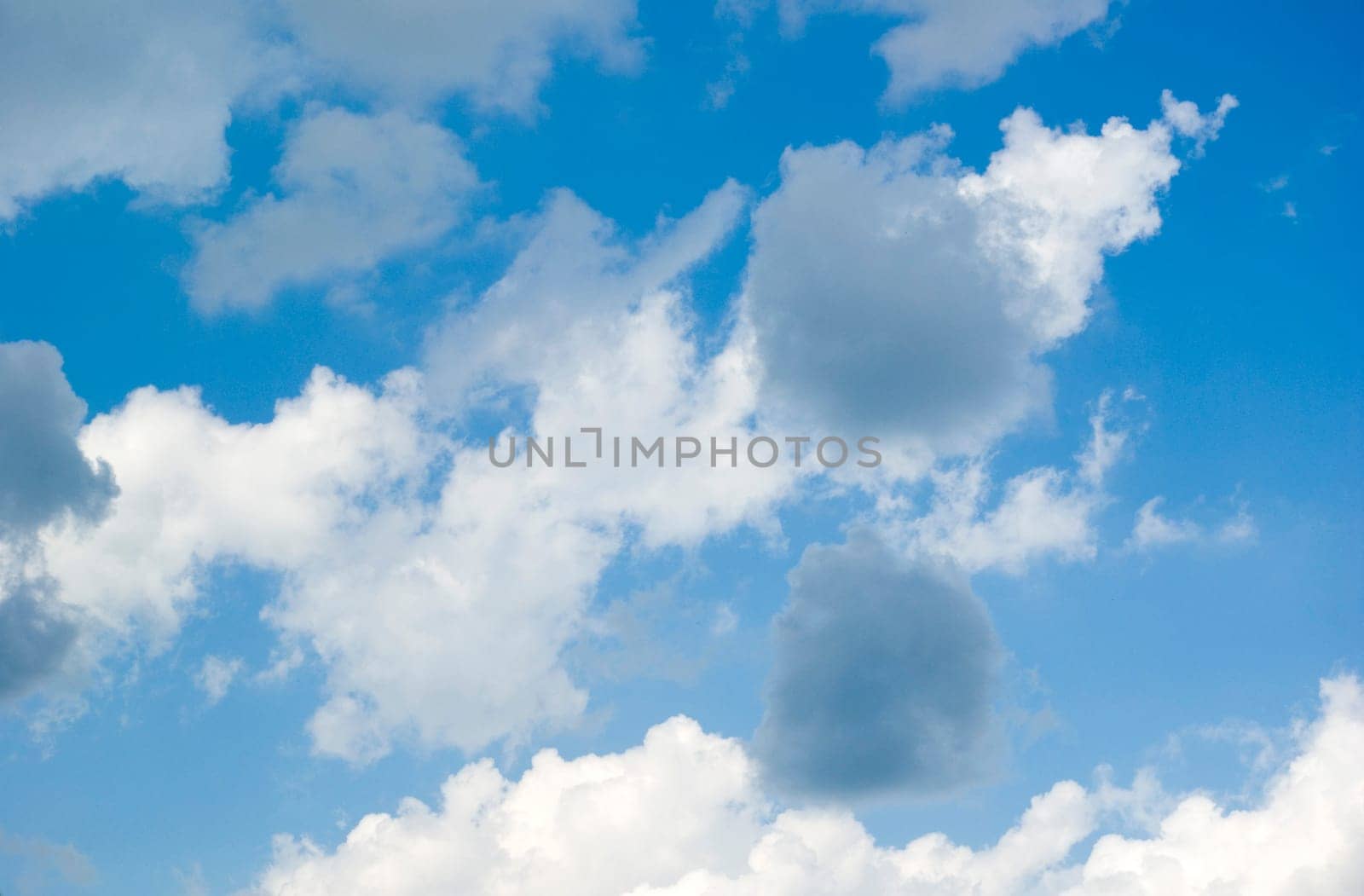 Blue sky background with tiny clouds