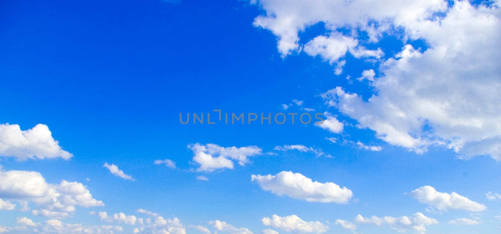 Blue sky background with tiny clouds
