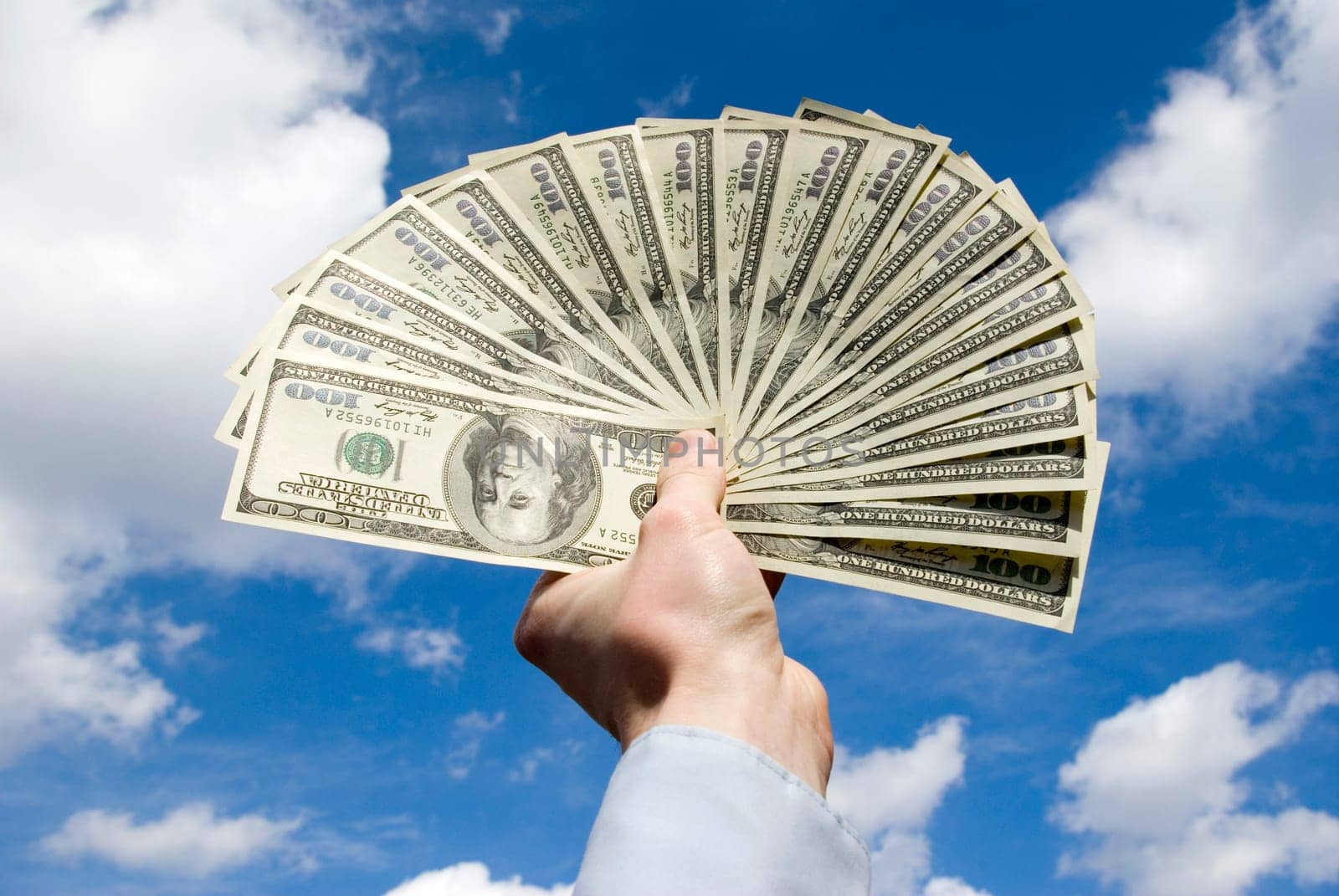 Money in hand  isolated on sky background