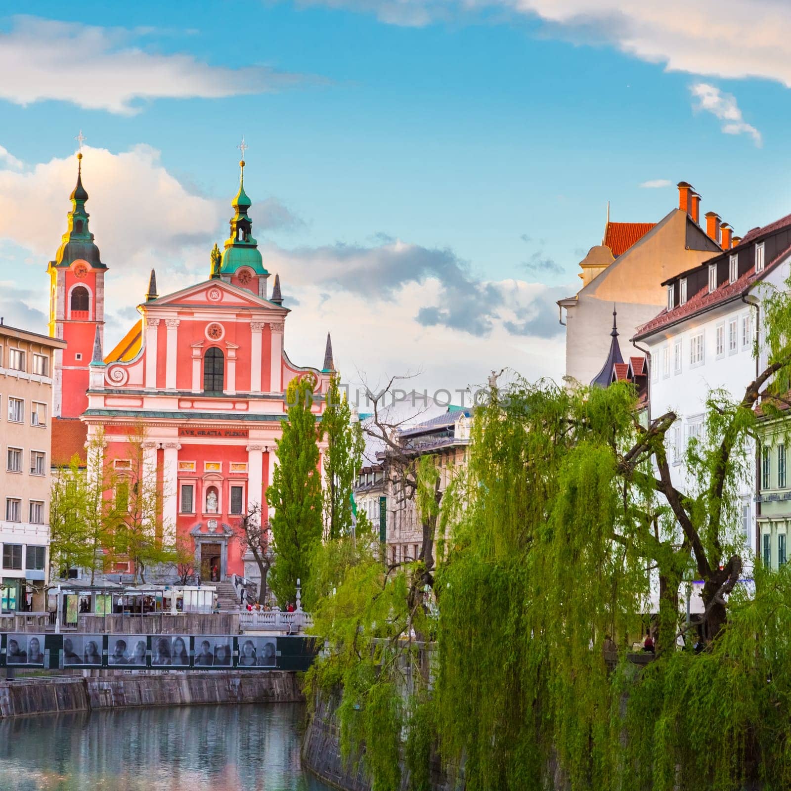 Romantic medieval Ljubljana's city center, capital of Slovenia, Europe. Banks of river Ljubljanica where many bars and restaurants take place. Franciscan Church in background