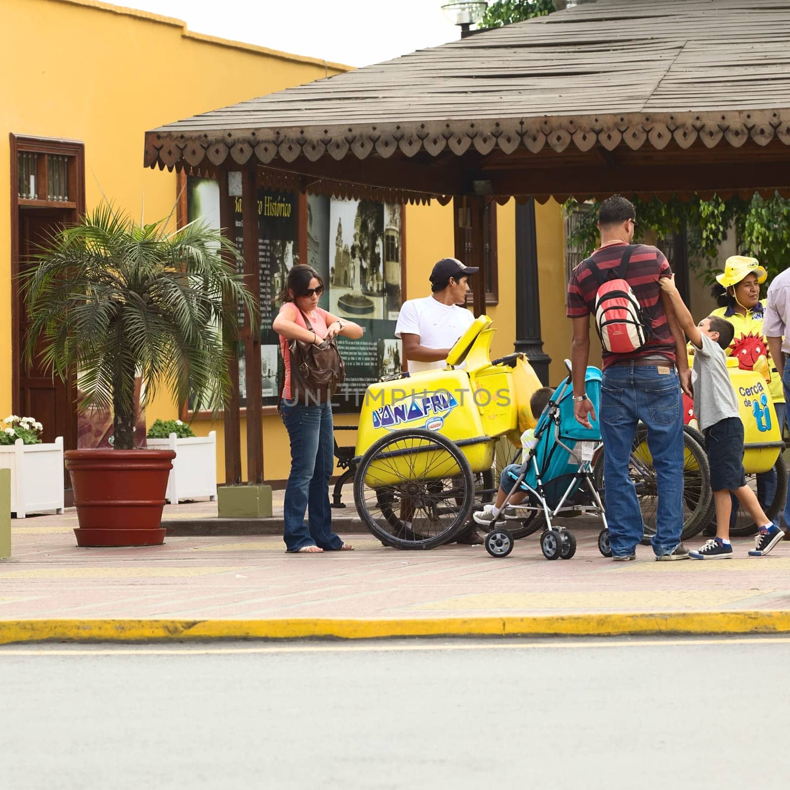 LIMA,PERU - APRIL 19,2012: Unidentified mobile ice cream vendor selling ice cream to unidentified people on Pedro de Osma Avenue in the district of Barranco on April 19,2012 in Lima,Peru.