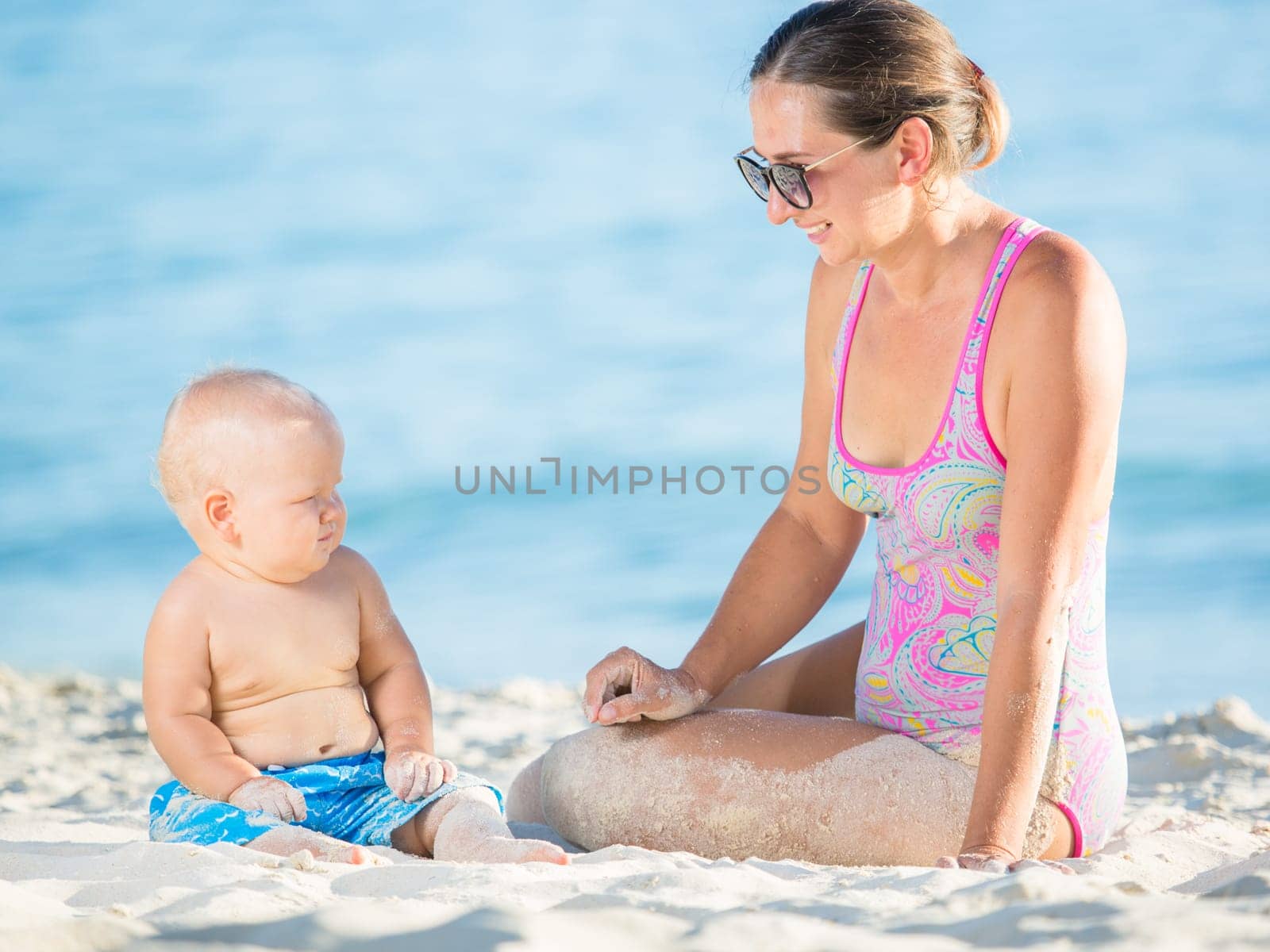 Baby and mother on the tropical beach