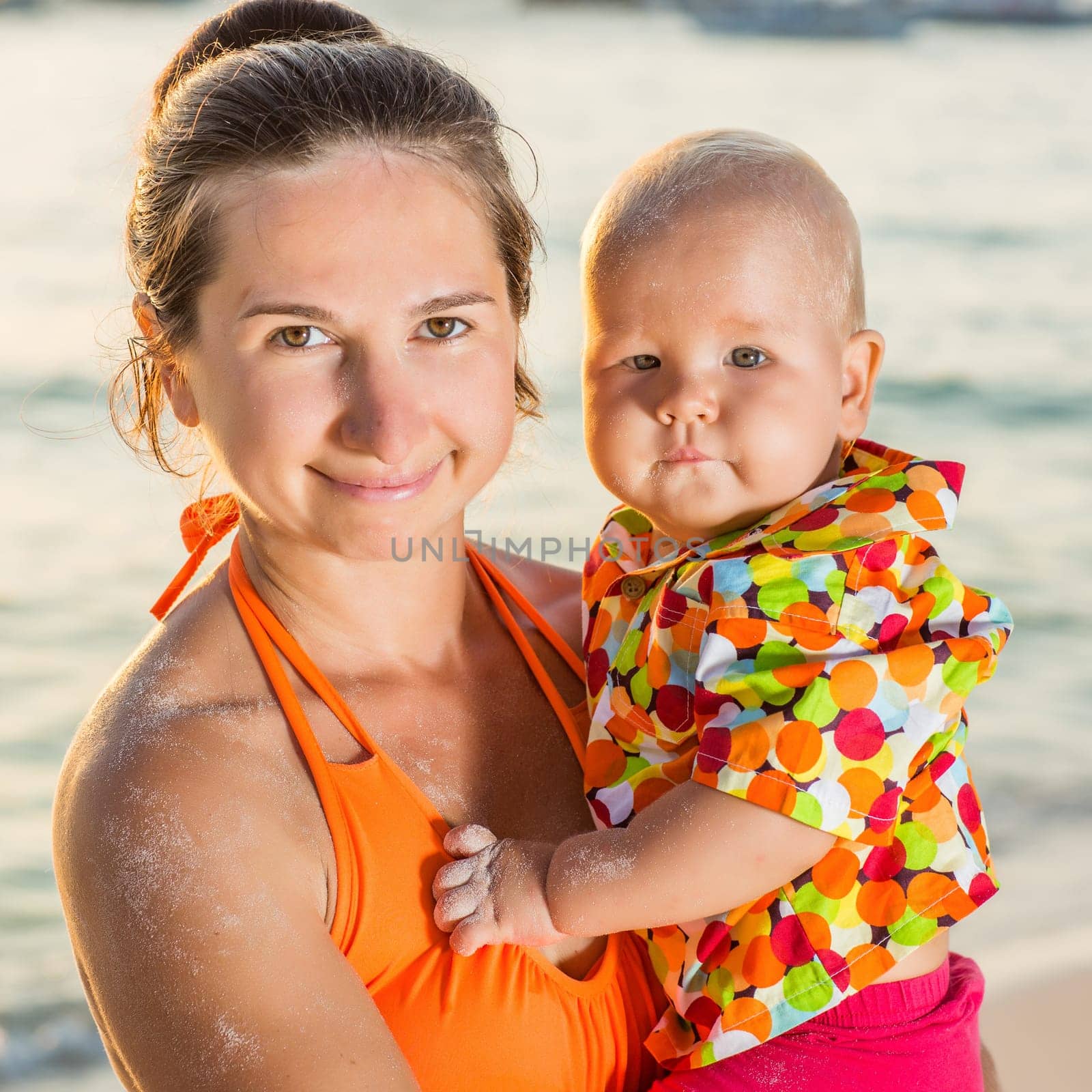 Baby and mother on the tropical beach