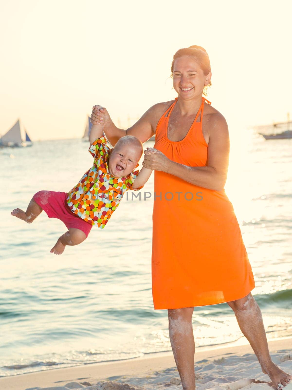 Baby and mother on the tropical beach