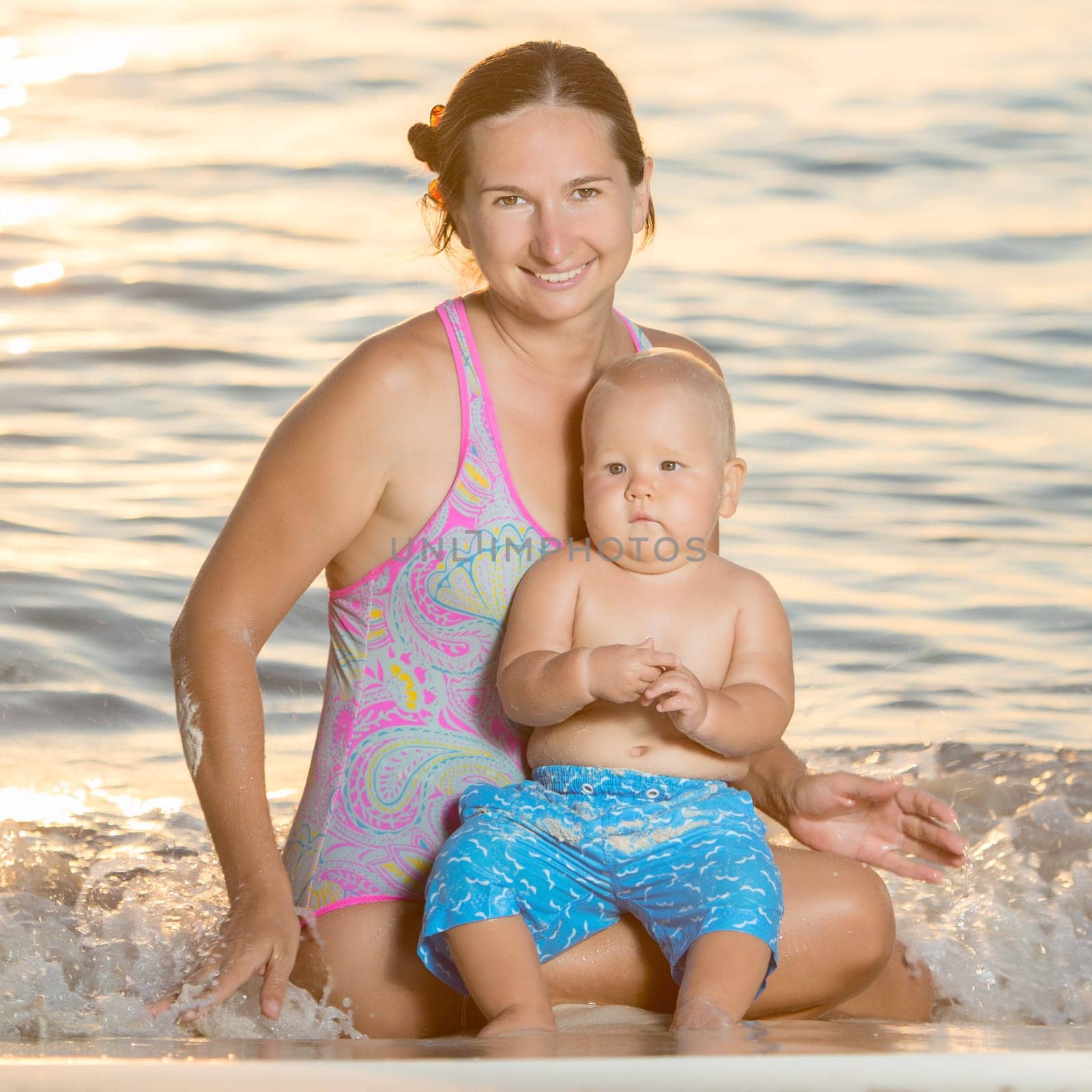 Baby and mother on the tropical beach