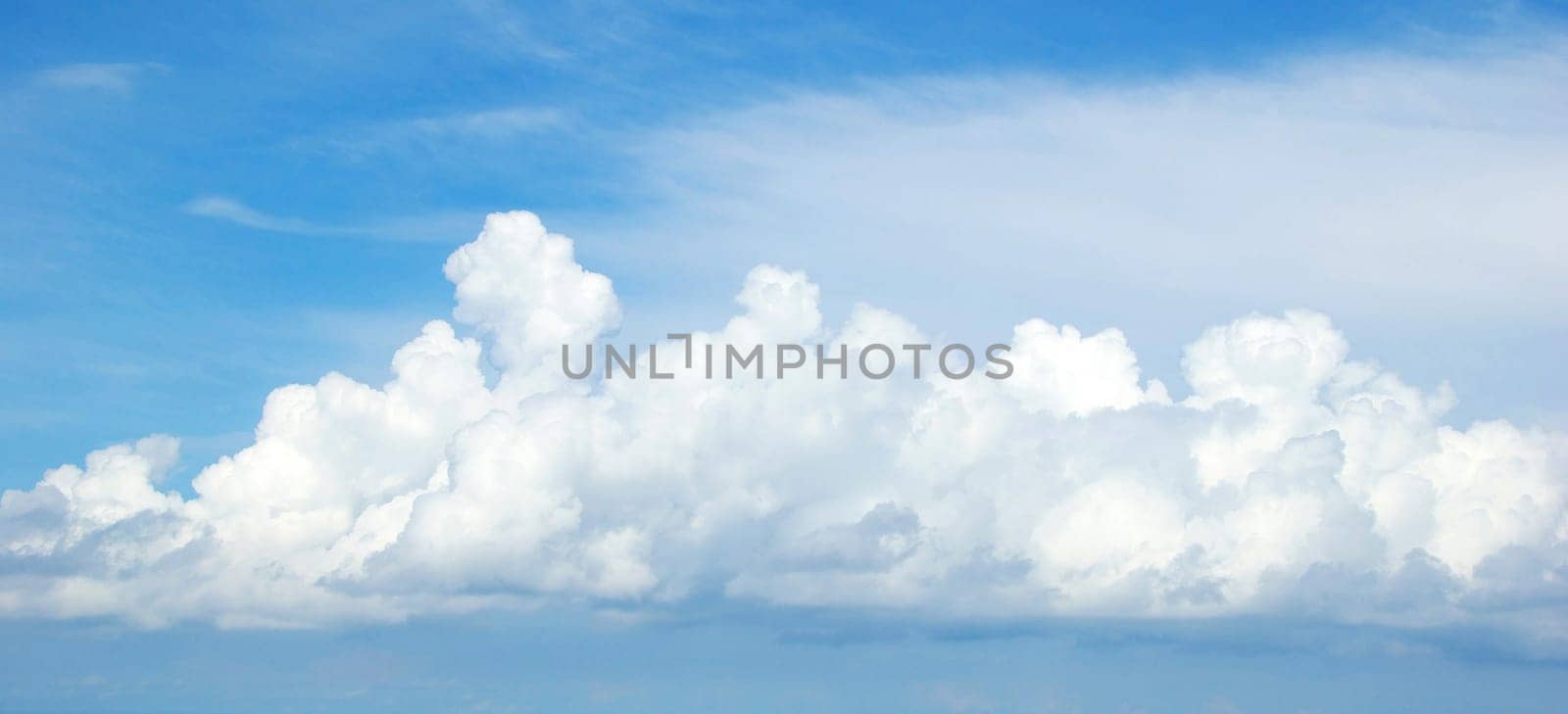 Blue sky background with tiny clouds