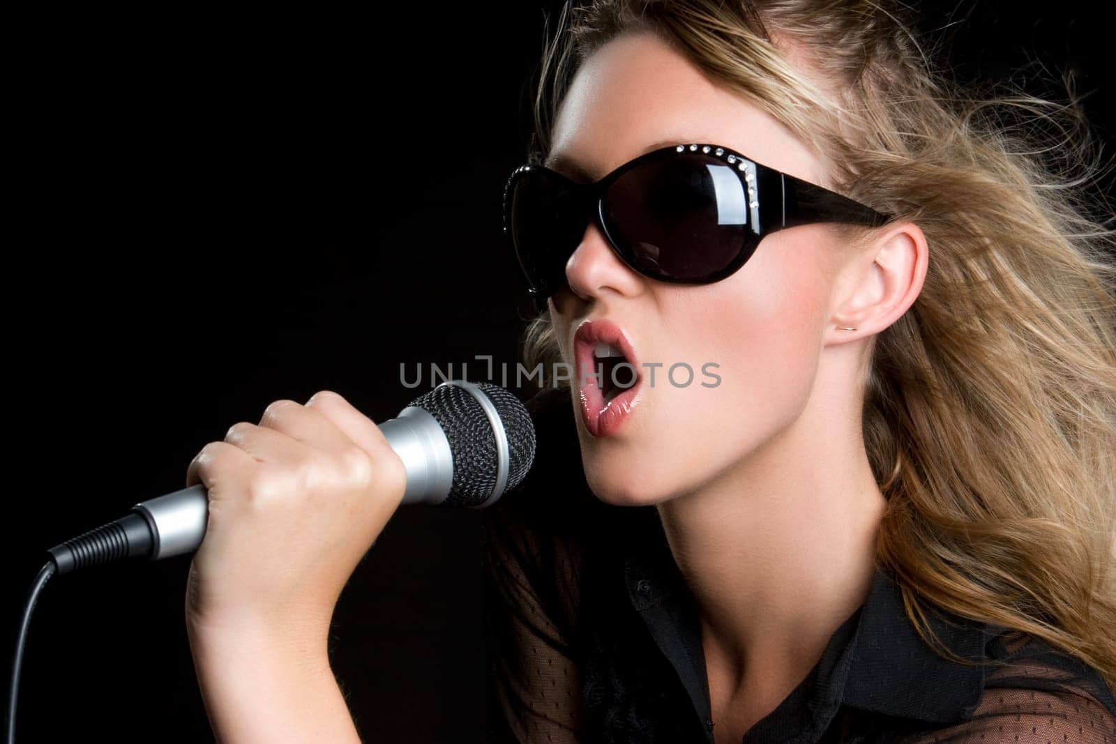 Beautiful young microphone singing woman