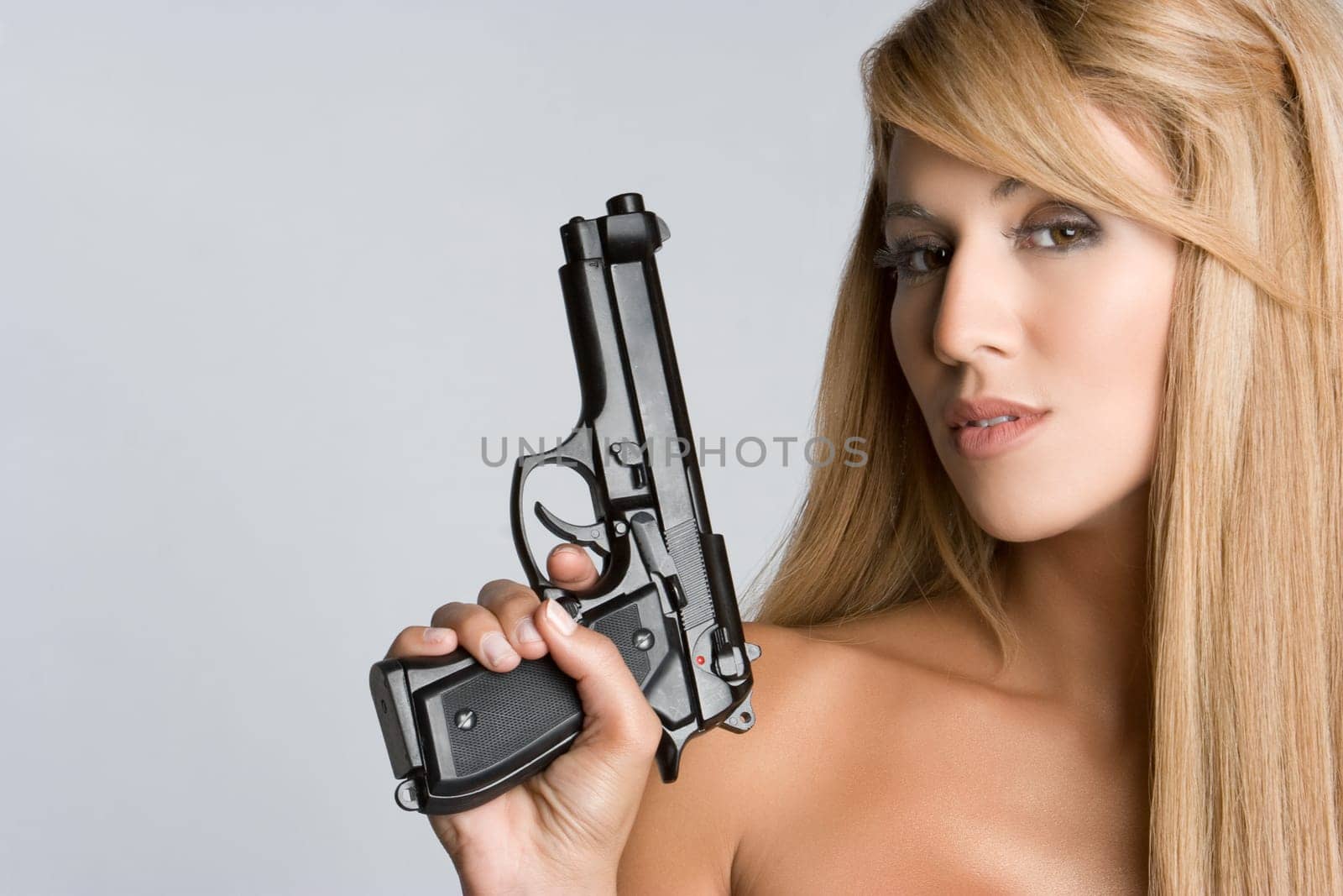 Beautiful sexy woman holding gun