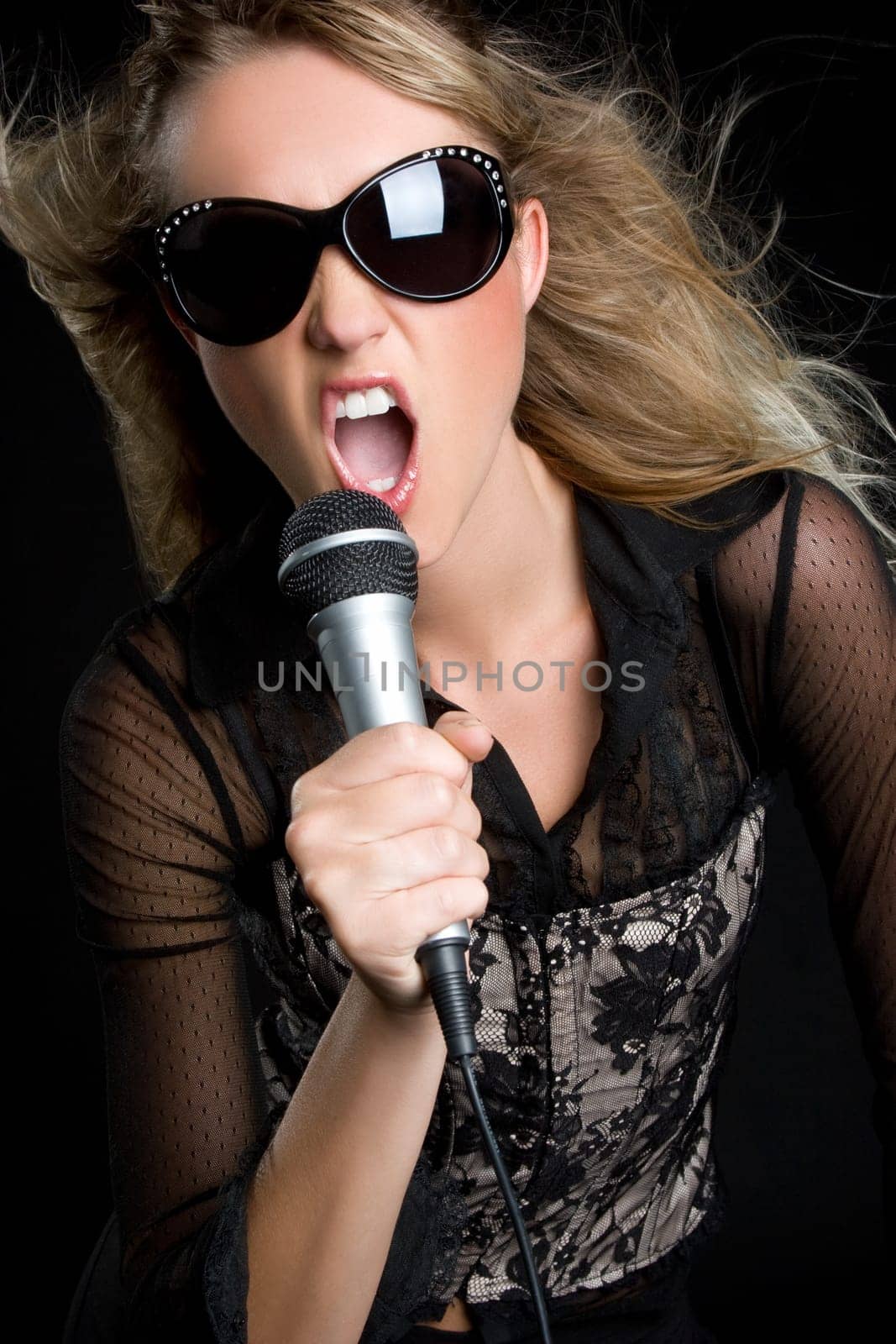Beautiful young blond woman singing