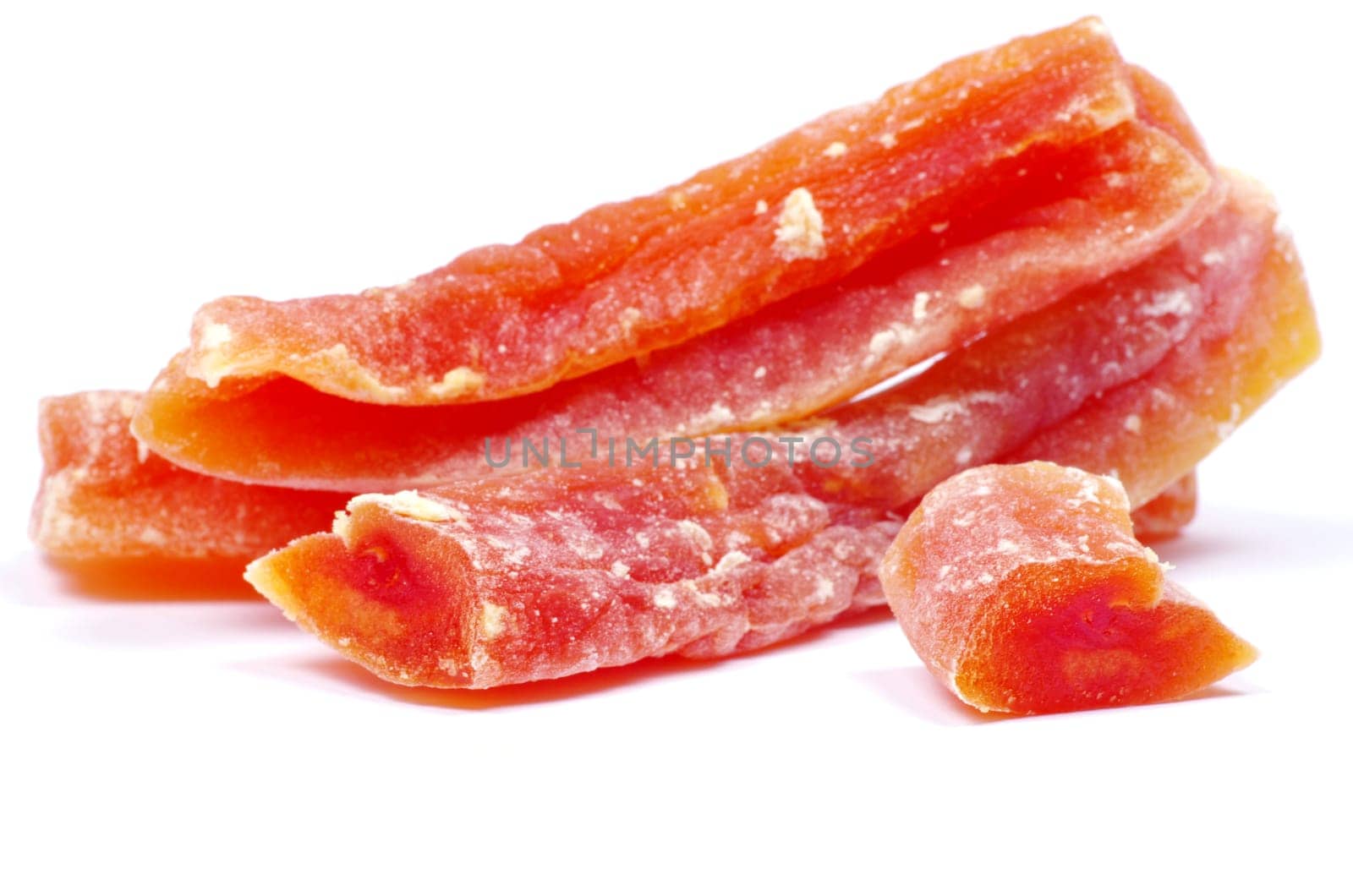 orange dried papaya slices over white background