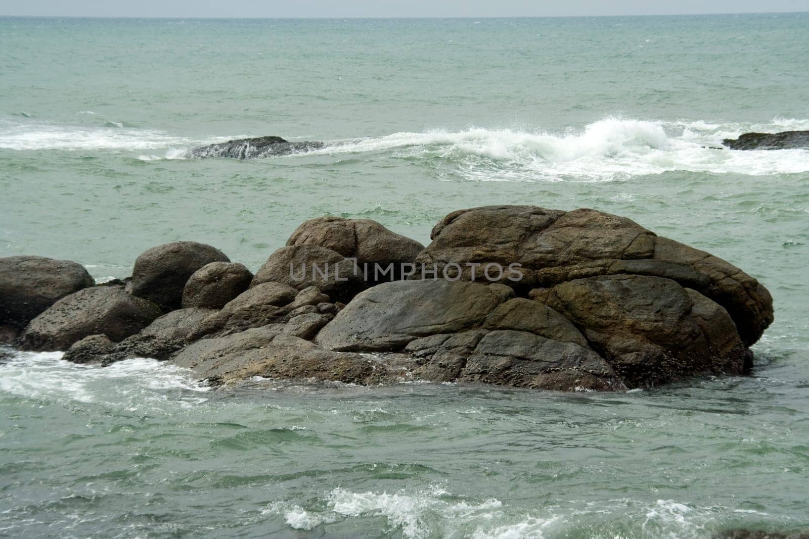 Bed of rock lying still in calm waters of vast ocean