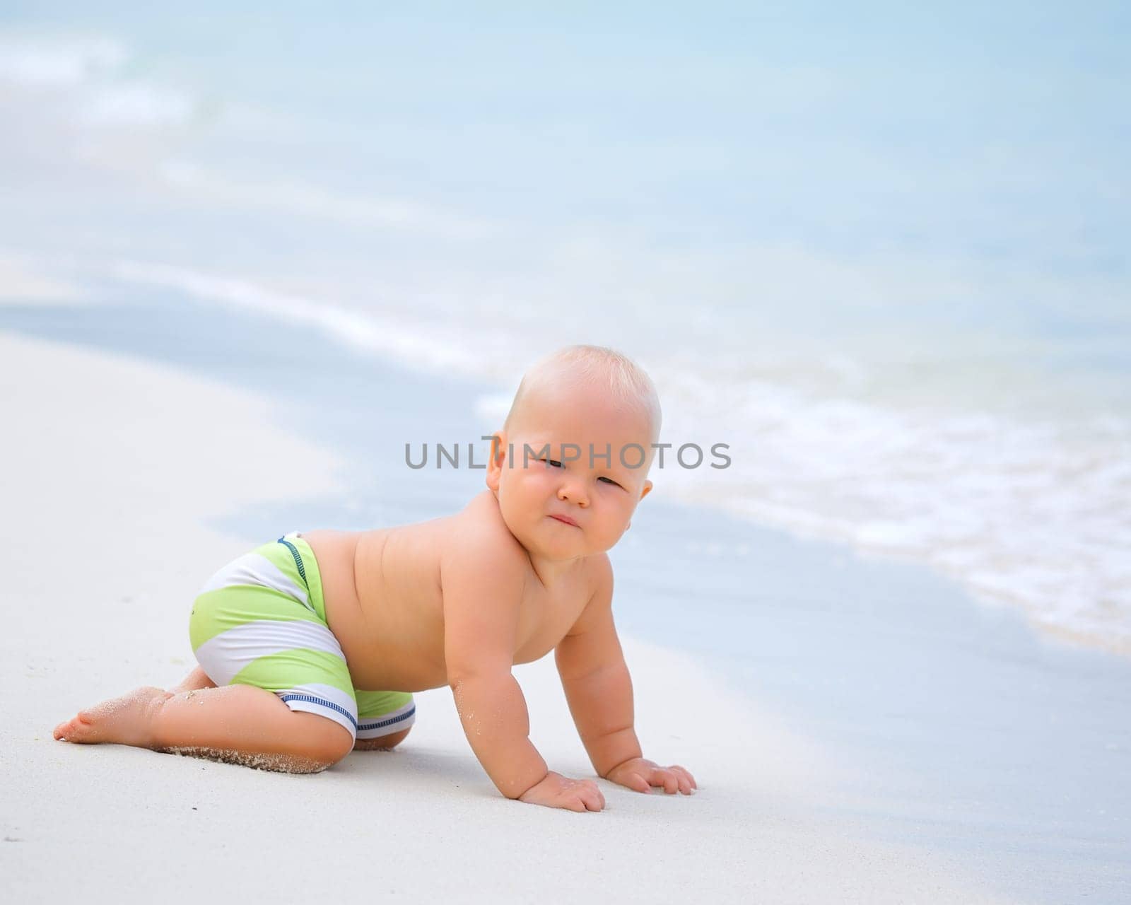Cute baby on the tropical beach