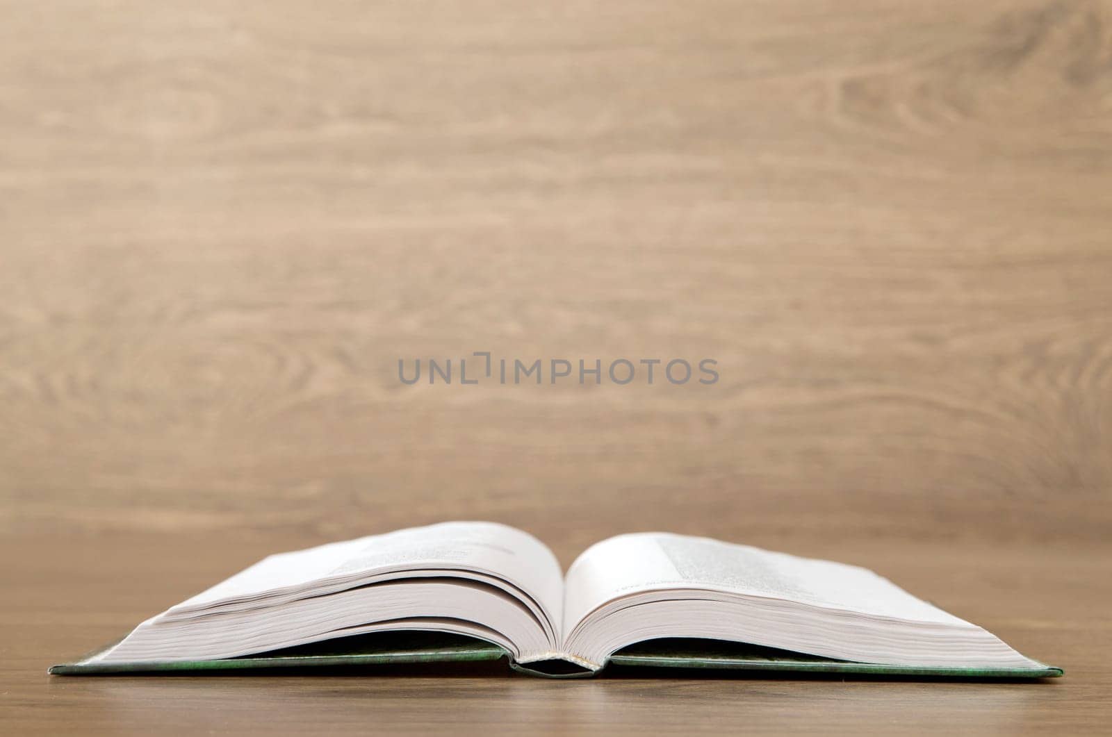Open book on wood background
