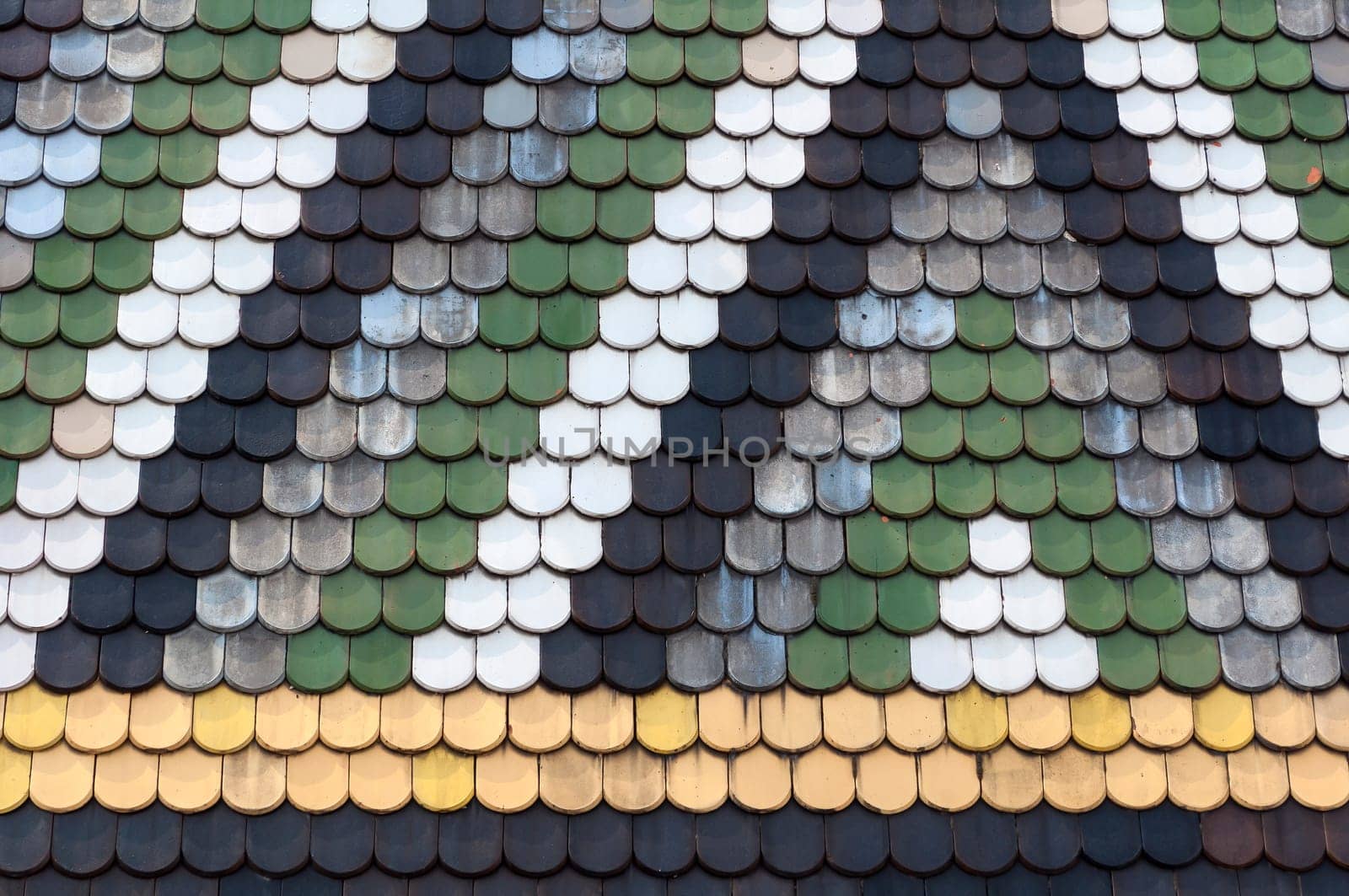 Detailed view of colorful wooden roof shingles.