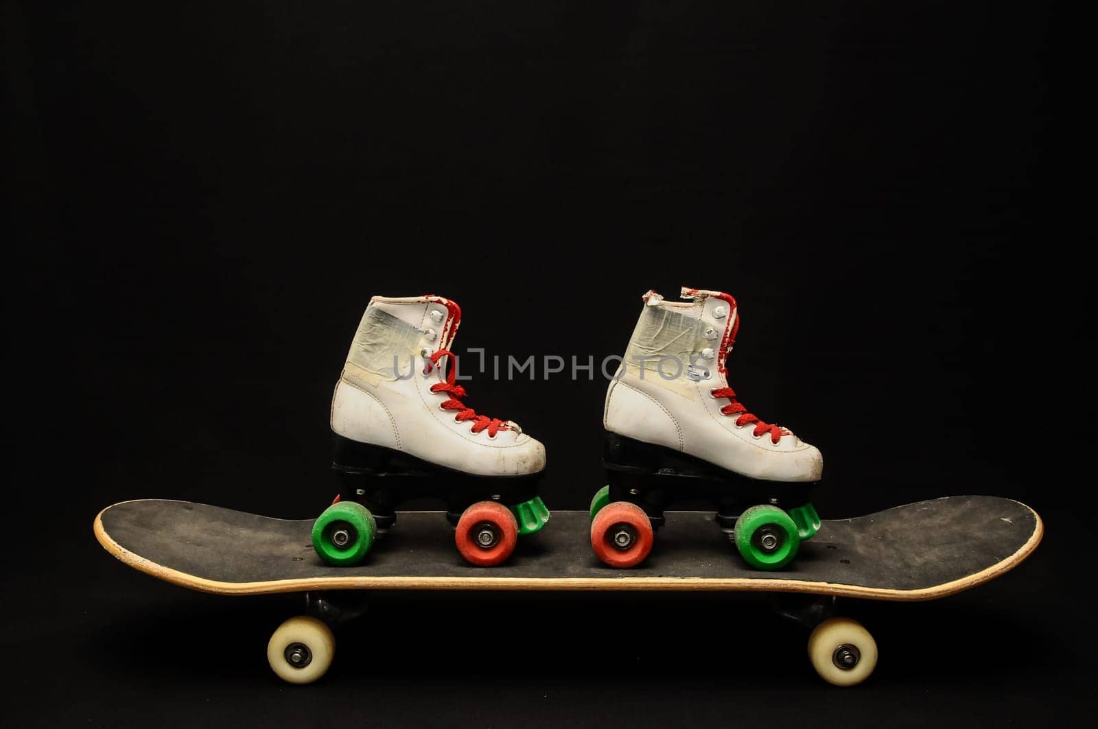Vintage Style Black Skateboard and Skate Boot on a Dark Background