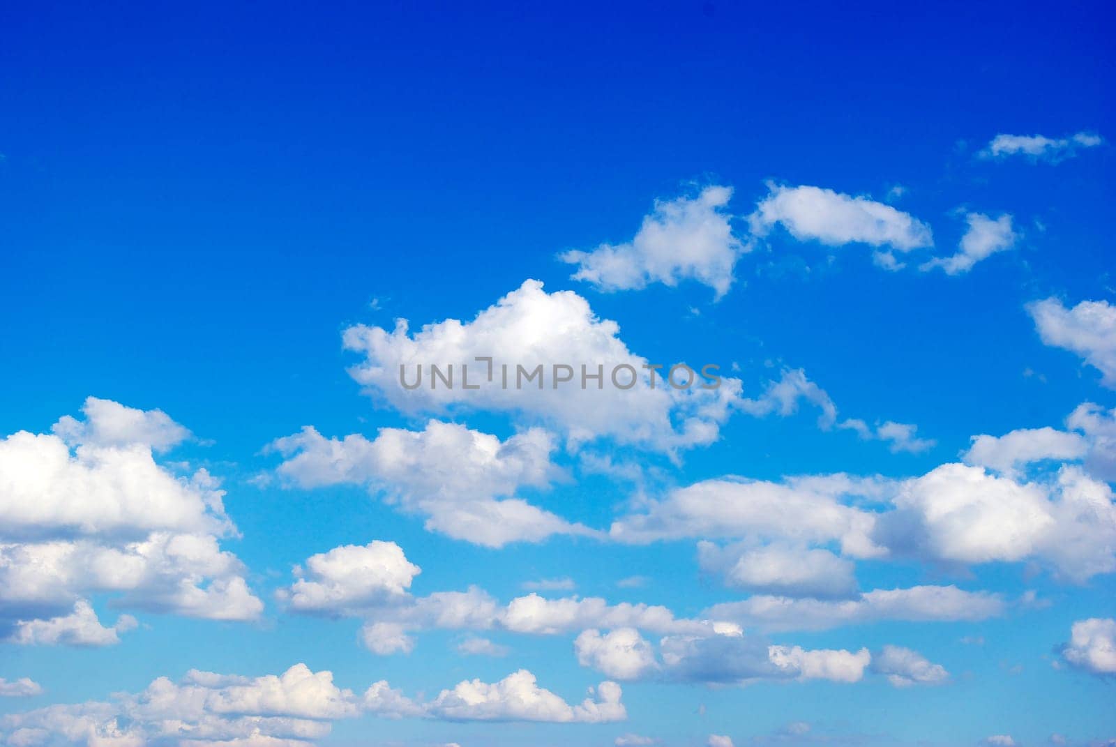 Blue sky background with tiny clouds