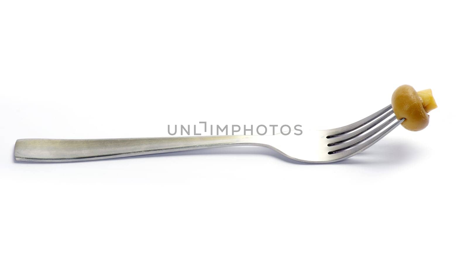 Fresh mushroom on a fork isolated on white background