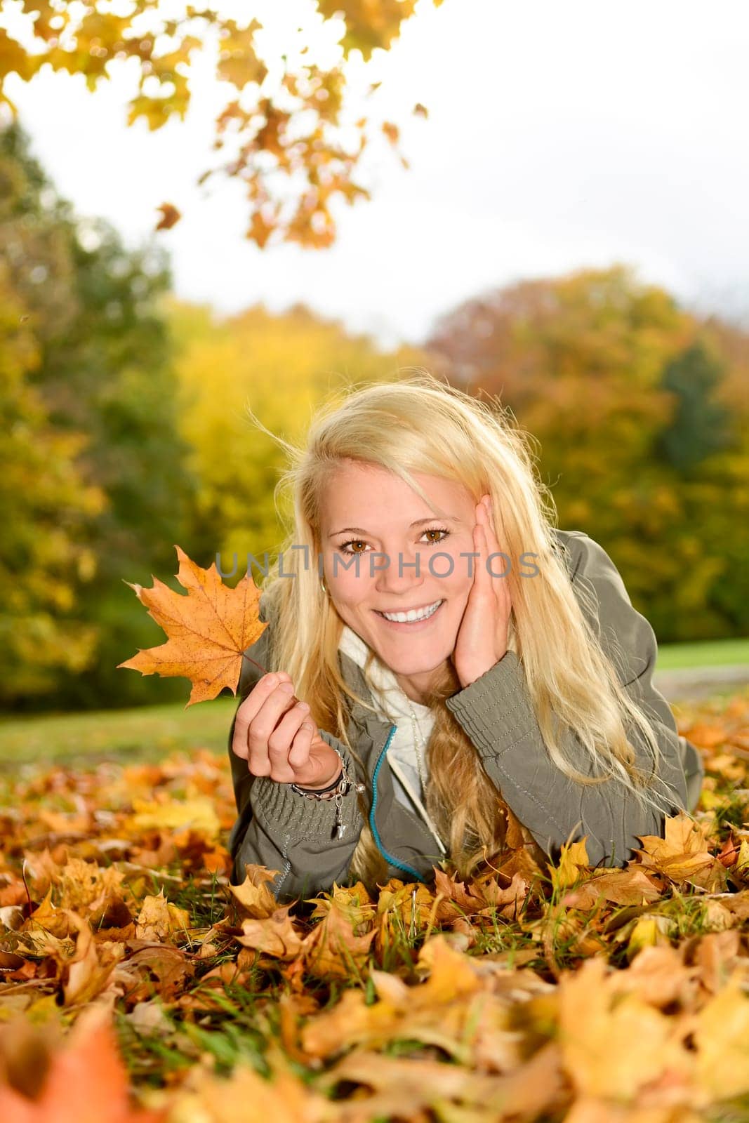 young woman with autumn leaf
