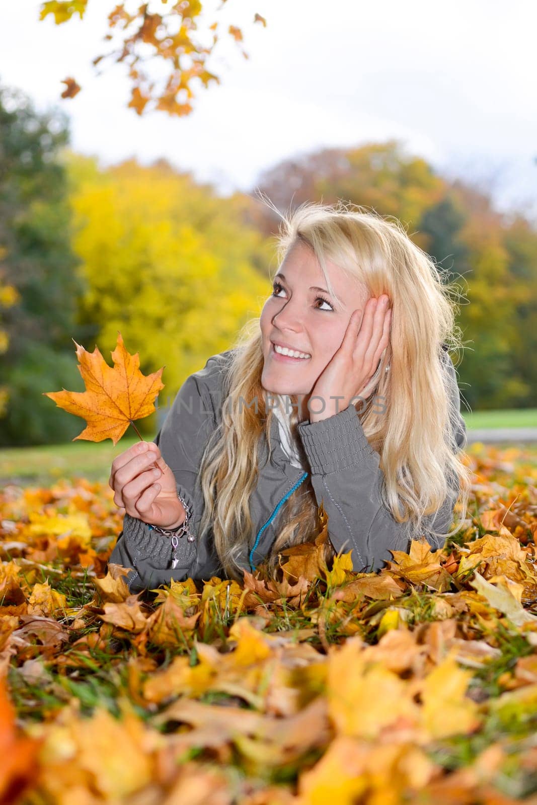 young woman with autumn leaf