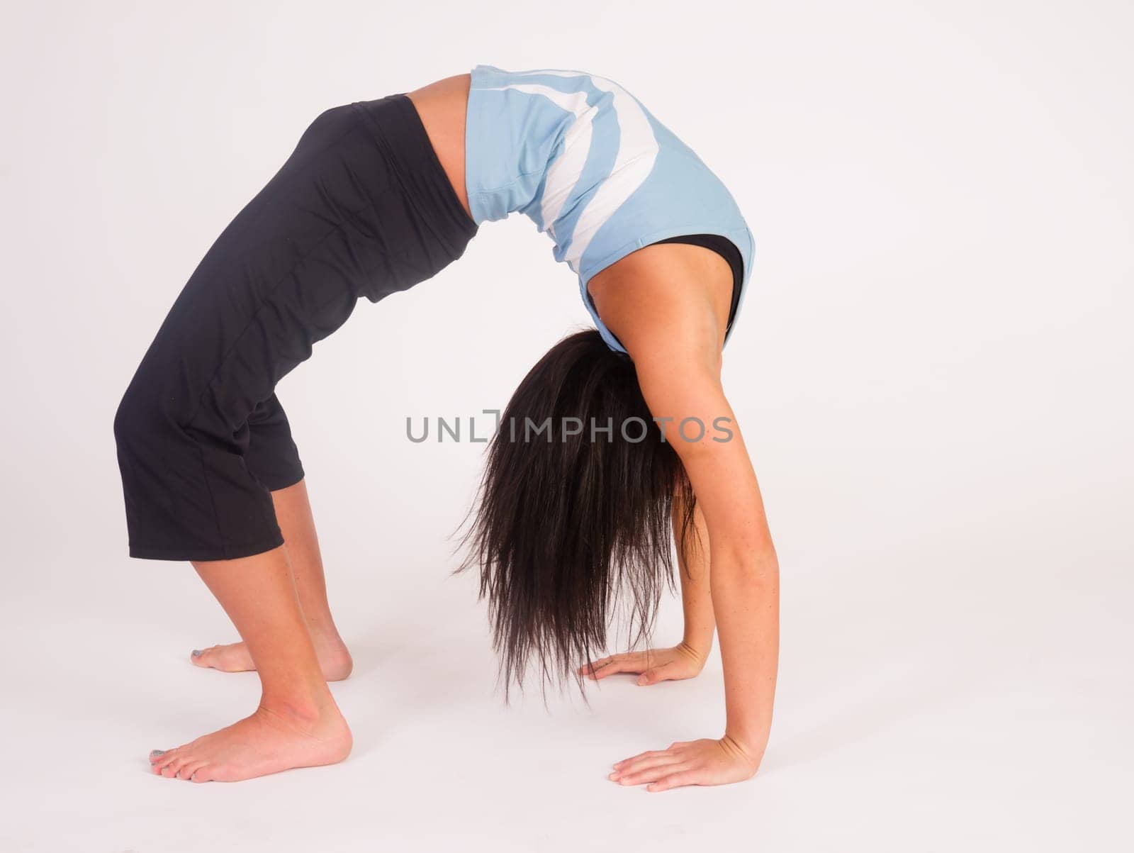 Young adult female prepares to turn herself back over after performing some stretches