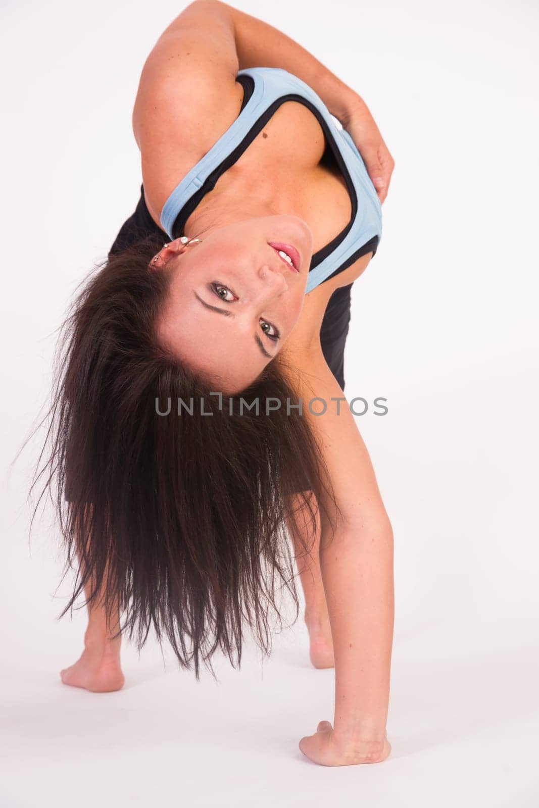 Young adult female prepares to turn herself back over after performing some stretches
